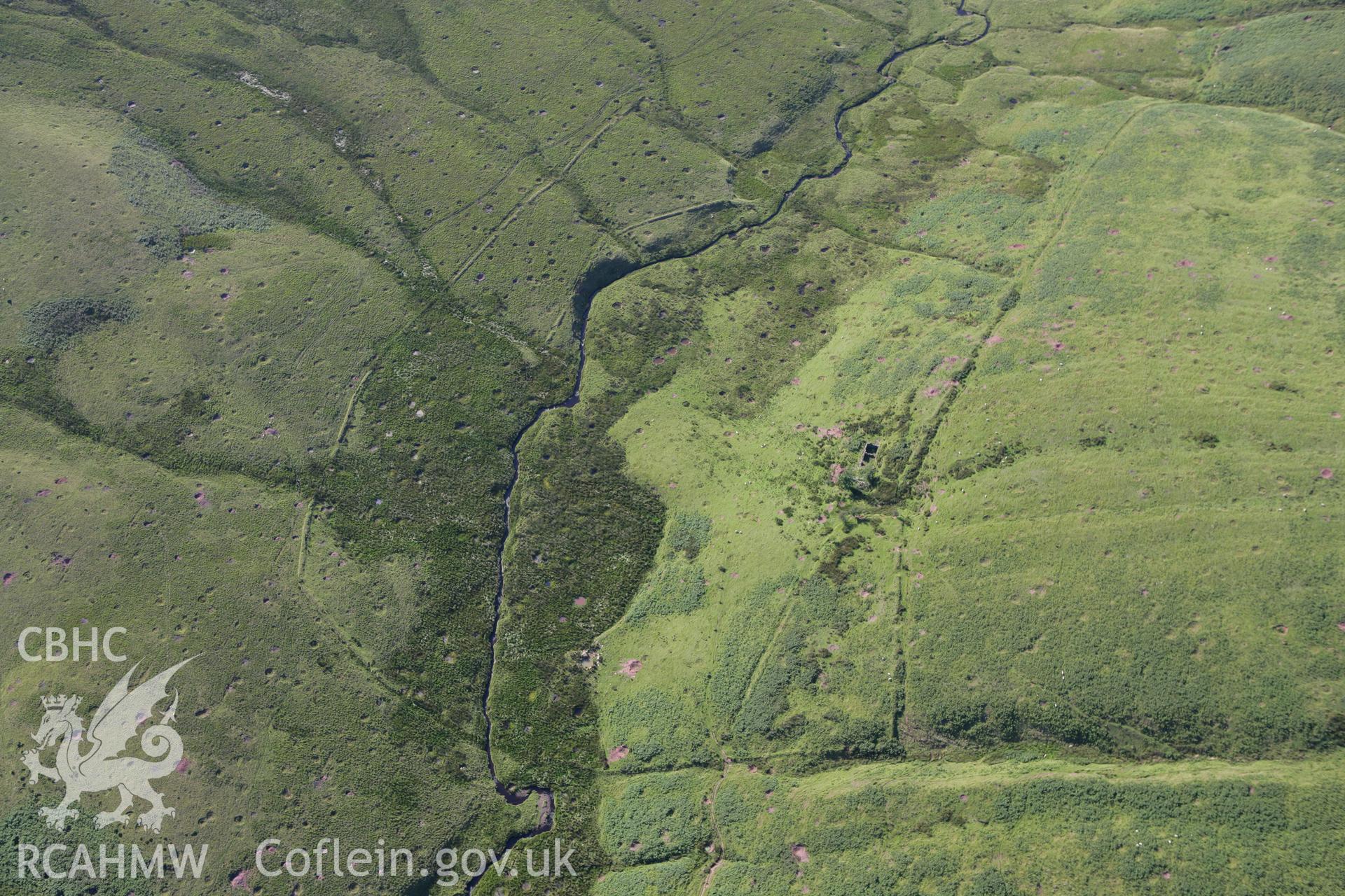 RCAHMW colour oblique aerial photograph of Cwm-car Deserted Farmstead. Taken on 08 August 2007 by Toby Driver