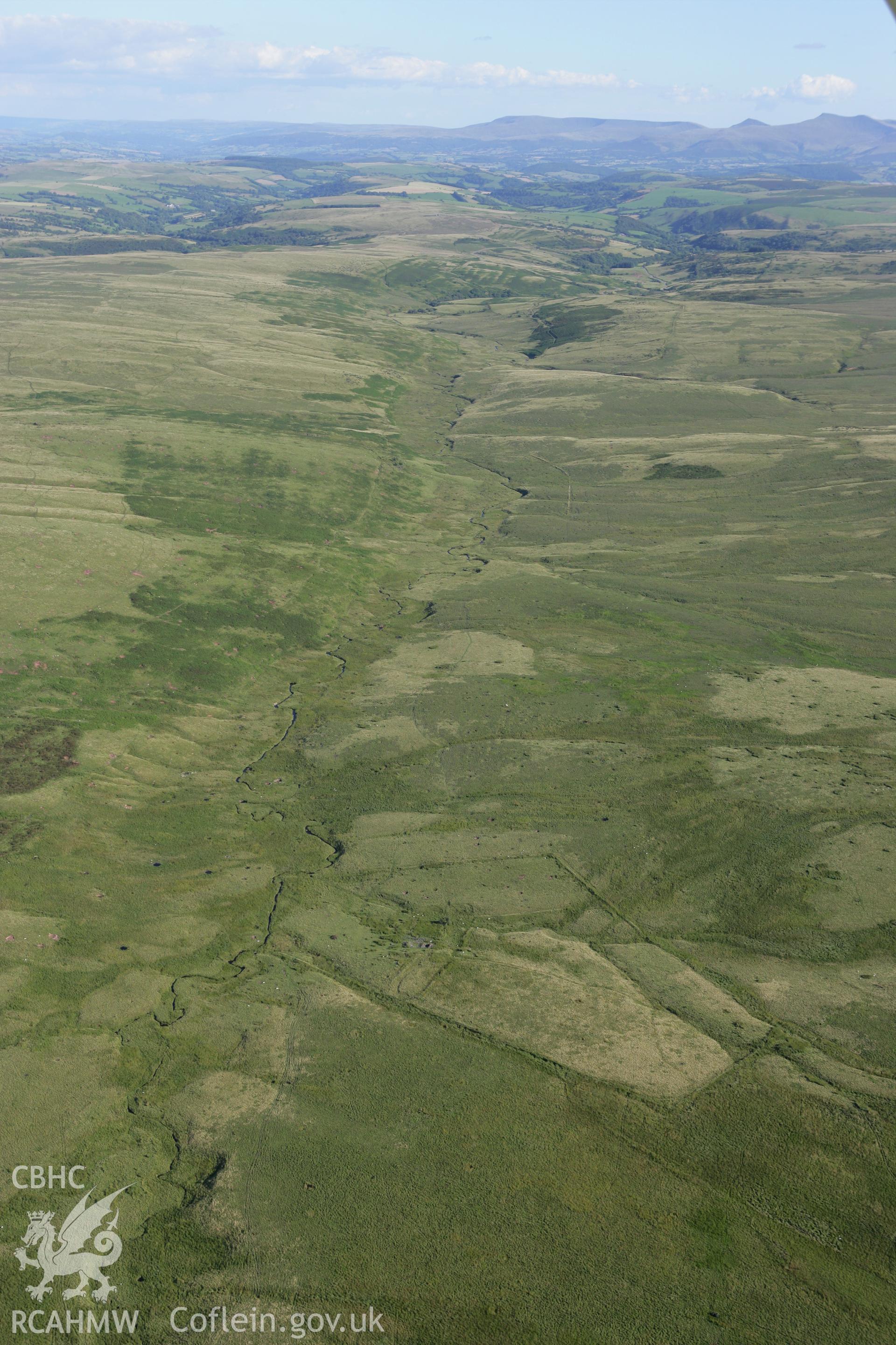 RCAHMW colour oblique aerial photograph of the farmstead at Ysgir Fechan and surrounding landscape, looking south. Taken on 08 August 2007 by Toby Driver