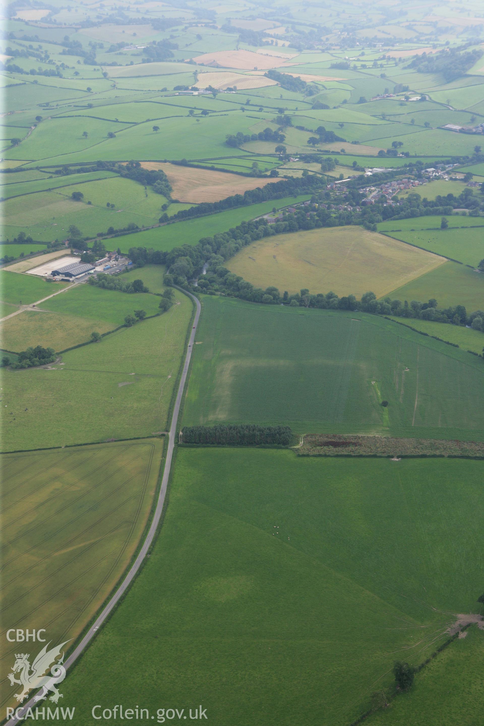 RCAHMW colour oblique photograph of Forden Gaer Roman Fort and Gaer Farm, Prehistoric Settlement. Taken by Toby Driver on 24/07/2008.