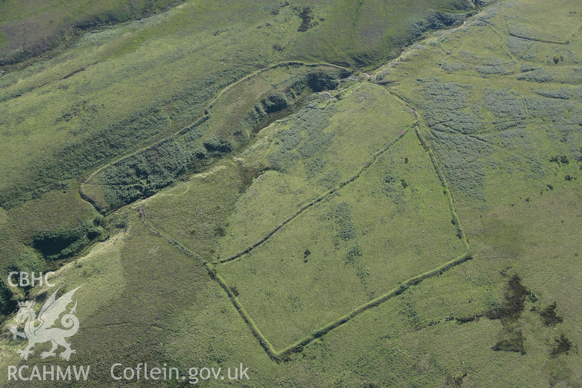 RCAHMW colour oblique aerial photograph of Pwll Cam West and surrounding landscape from the north. Taken on 08 August 2007 by Toby Driver