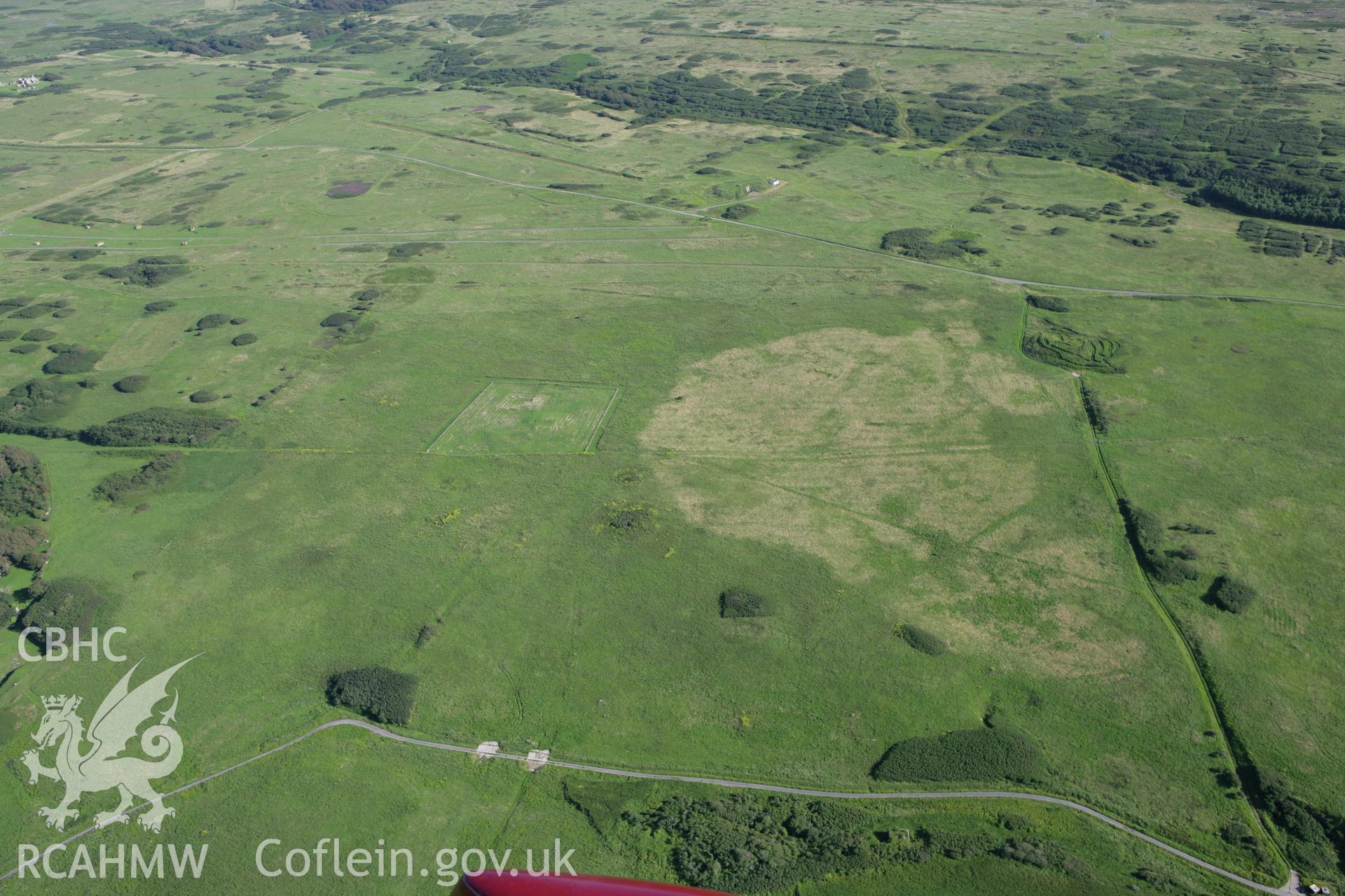 RCAHMW colour oblique aerial photograph of Brownslade Round Barrow, Castlemartin, and surrounding landscape. Taken on 30 July 2007 by Toby Driver