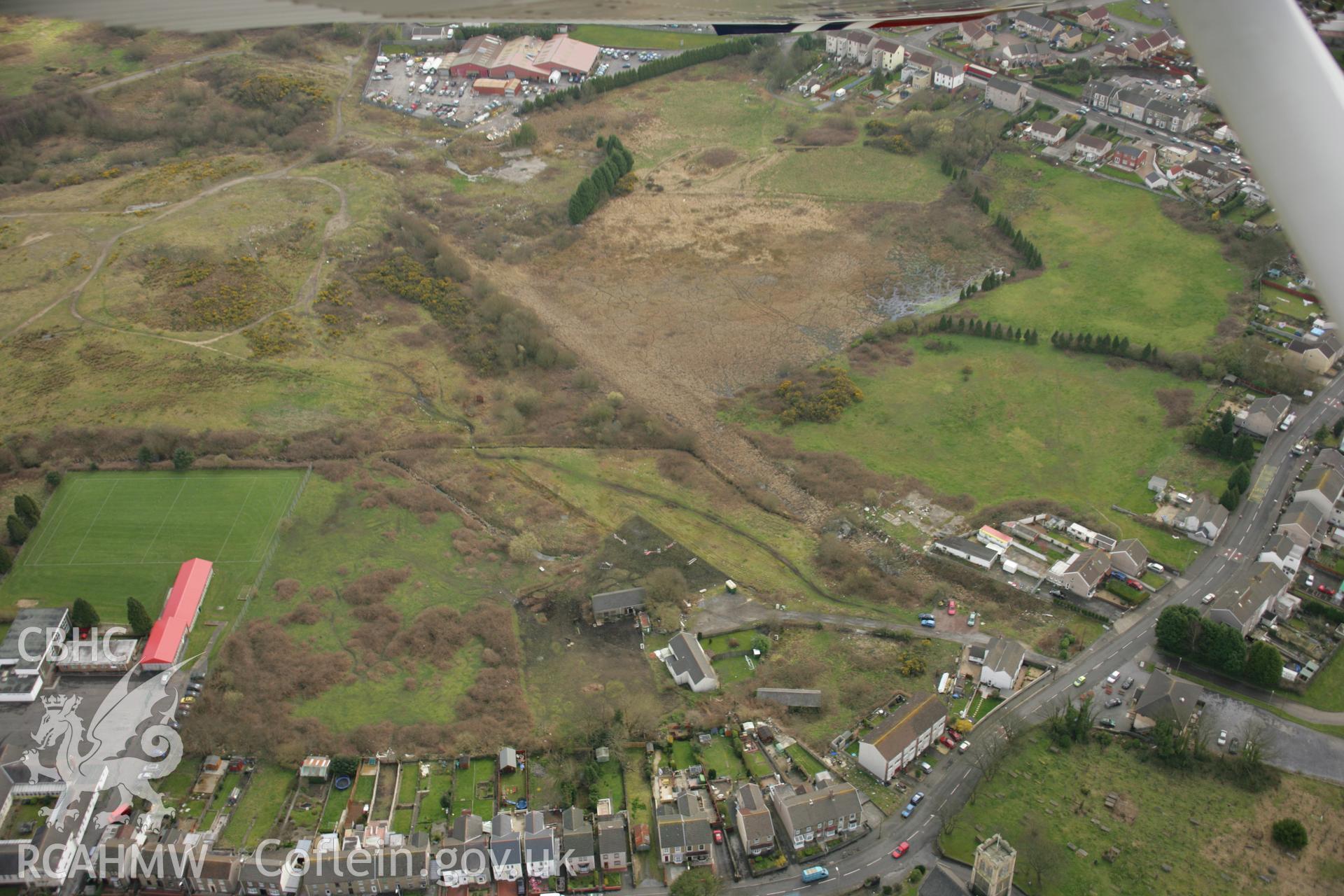 RCAHMW colour oblique aerial photograph of St Samlet's Church, Llansamlet, with the former line of the canal visible. Taken on 16 March 2007 by Toby Driver