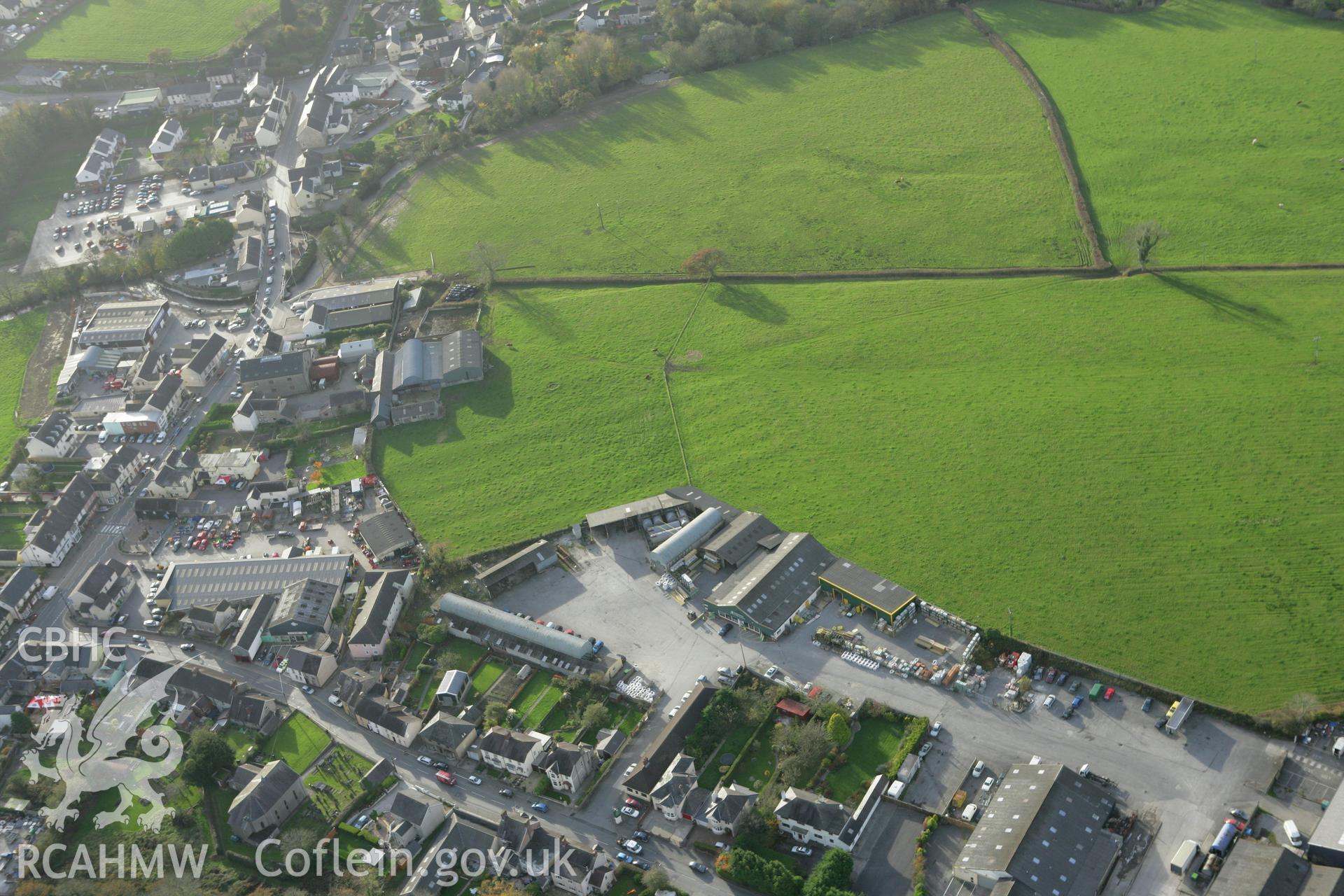 RCAHMW colour oblique photograph of St Clears Farmers Co-operative stores and mills; earthworks of former ridge and furrow, St. Clears. Taken by Toby Driver on 06/11/2007.