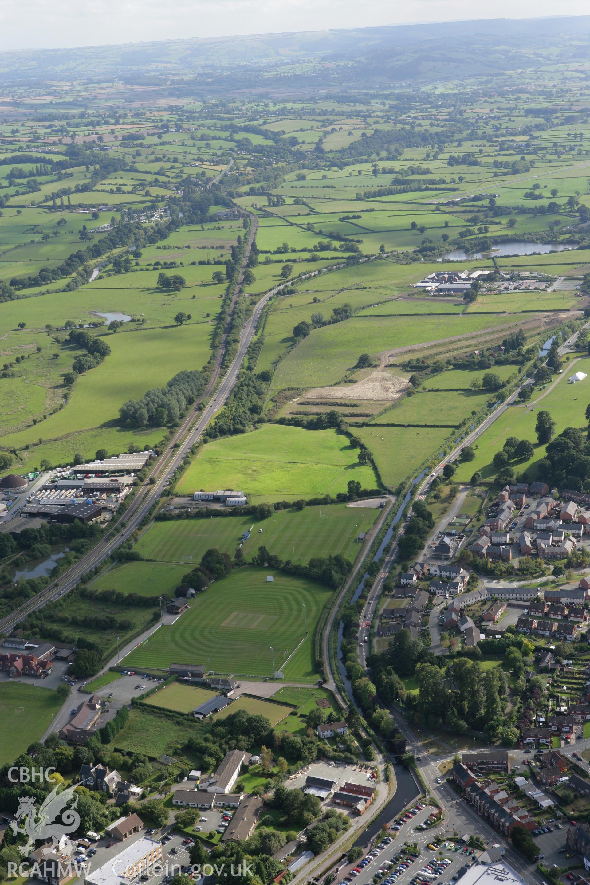 RCAHMW colour oblique aerial photograph of Welshpool and the Montgomeryshire Canal to the south. Taken on 06 September 2007 by Toby Driver