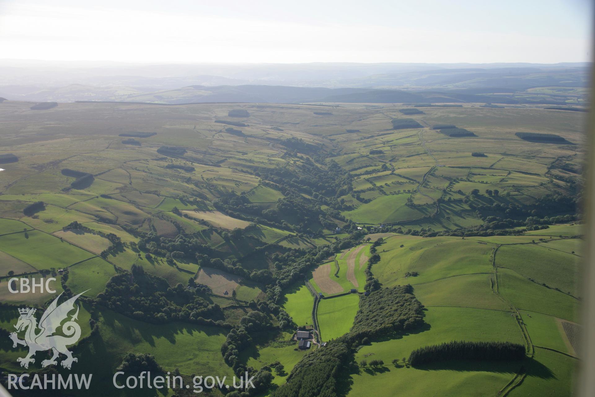 RCAHMW colour oblique aerial photograph of Llandeilo'r Fan village. Taken on 08 August 2007 by Toby Driver