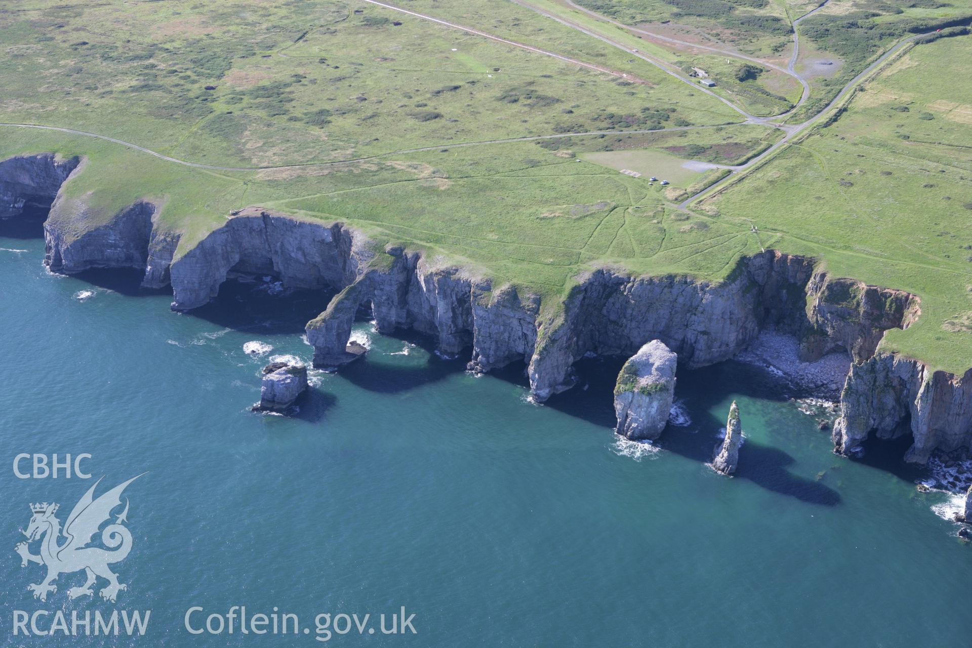 RCAHMW colour oblique aerial photograph of the Green Bridge (of Wales) and Elegug Stacks. Taken on 30 July 2007 by Toby Driver