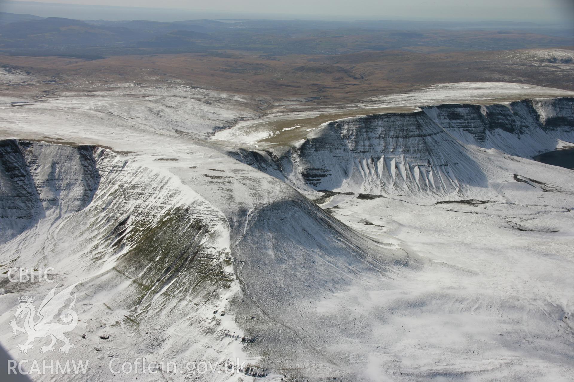 RCAHMW colour oblique aerial photograph of Fan Foel Round Barrow and Bannau Sir Gaer in winter landscape. Taken on 21 March 2007 by Toby Driver
