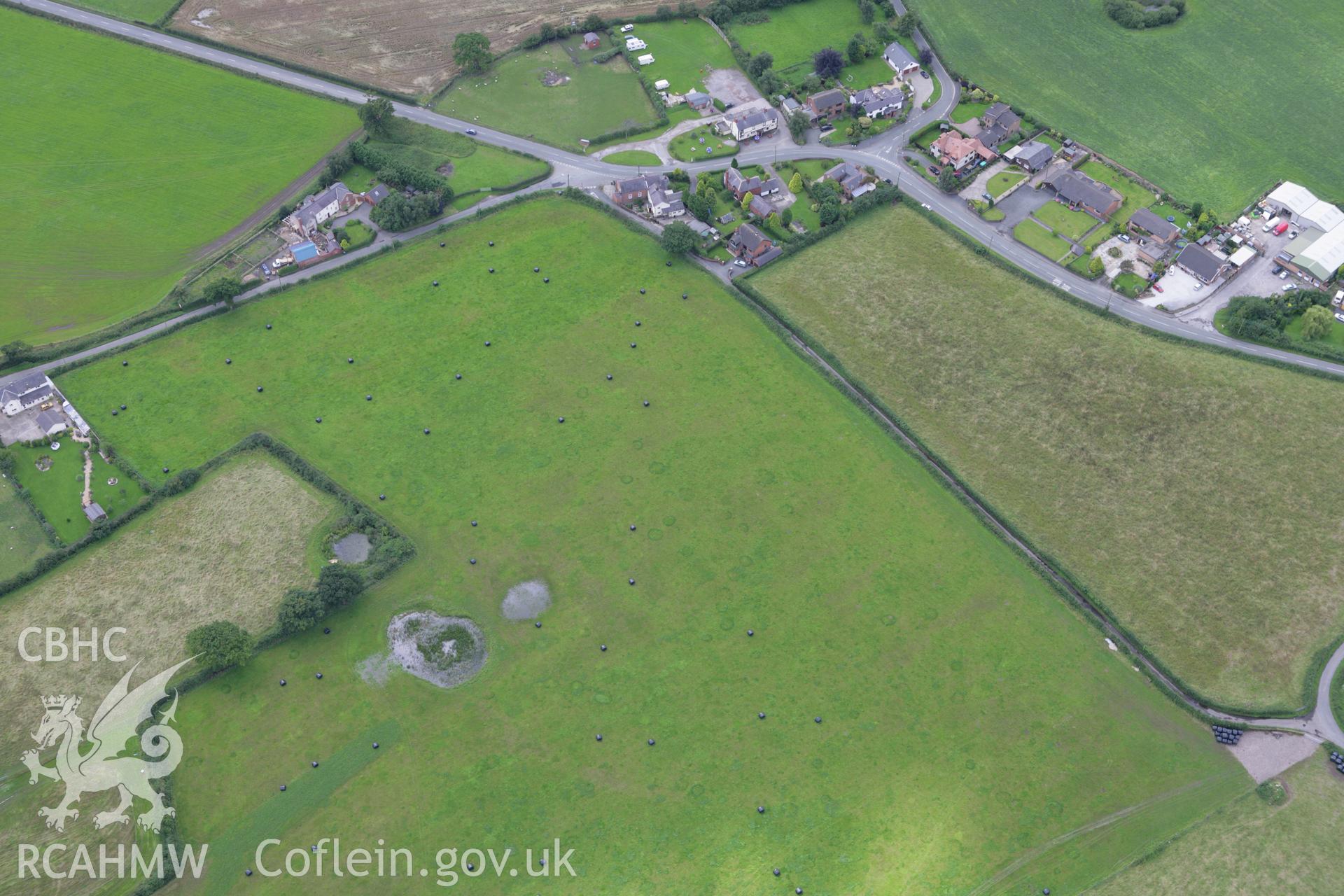 RCAHMW colour oblique aerial photograph of Trevalyn village, showing Trefalun English Congregational Chapel (Allington), Trefalun. Taken on 24 July 2007 by Toby Driver