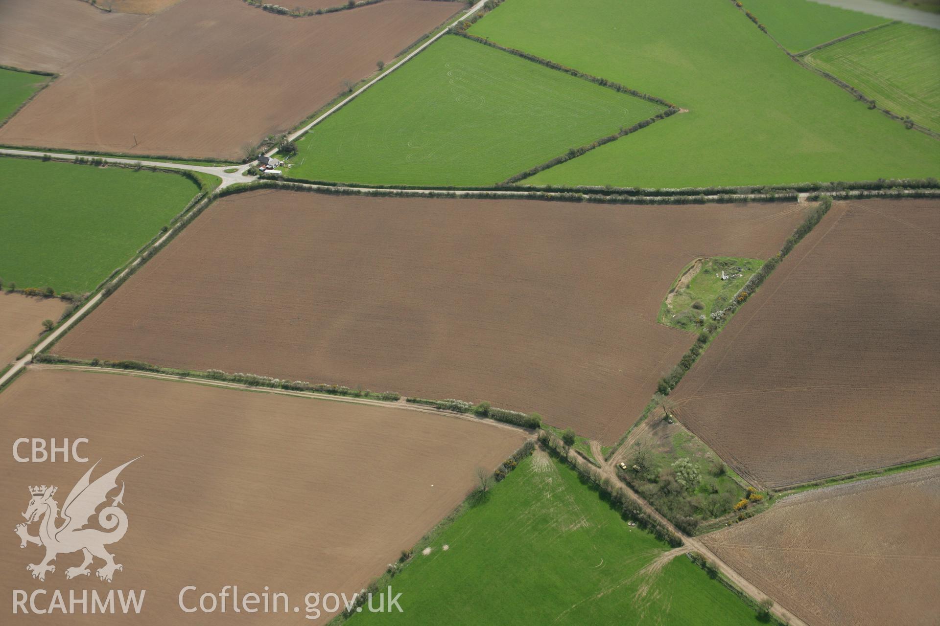 RCAHMW colour oblique aerial photograph of the Post-Coch cropmark enclosure northeast  of Nevern. Taken on 17 April 2007 by Toby Driver