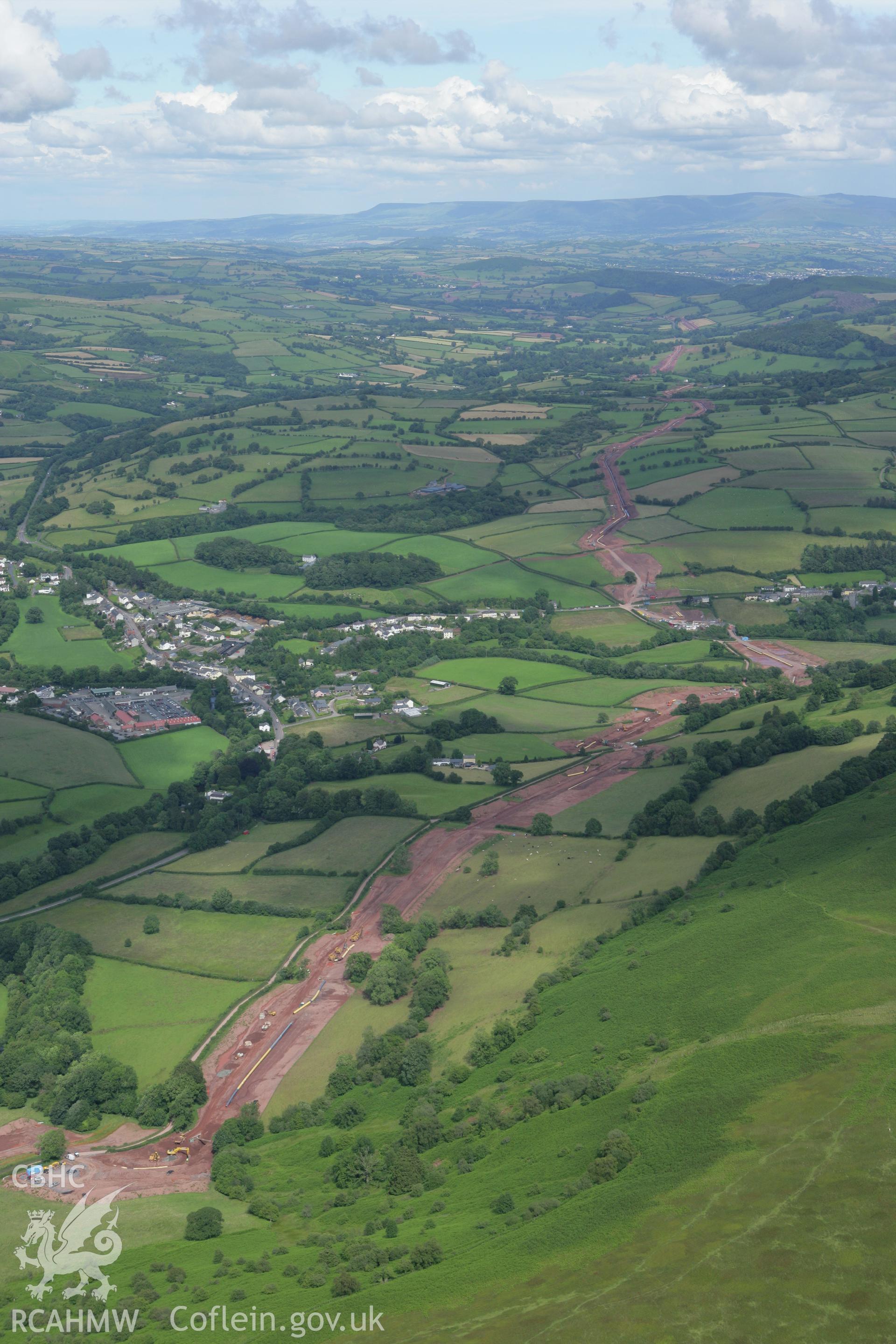 RCAHMW colour oblique aerial photograph of Sennybridge showing the gas pipeline from the west. Taken on 09 July 2007 by Toby Driver