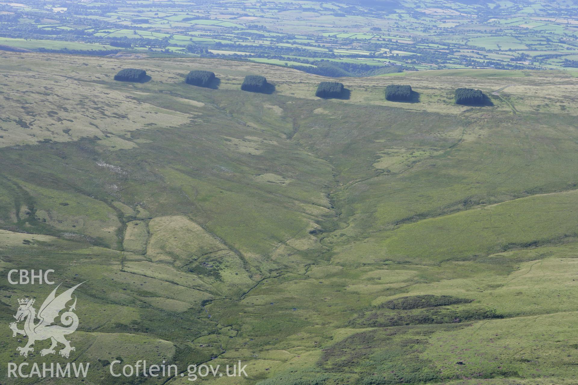 RCAHMW colour oblique aerial photograph of the farmstead at Ysgir Fechan and surrounding landscape, looking north. Taken on 08 August 2007 by Toby Driver