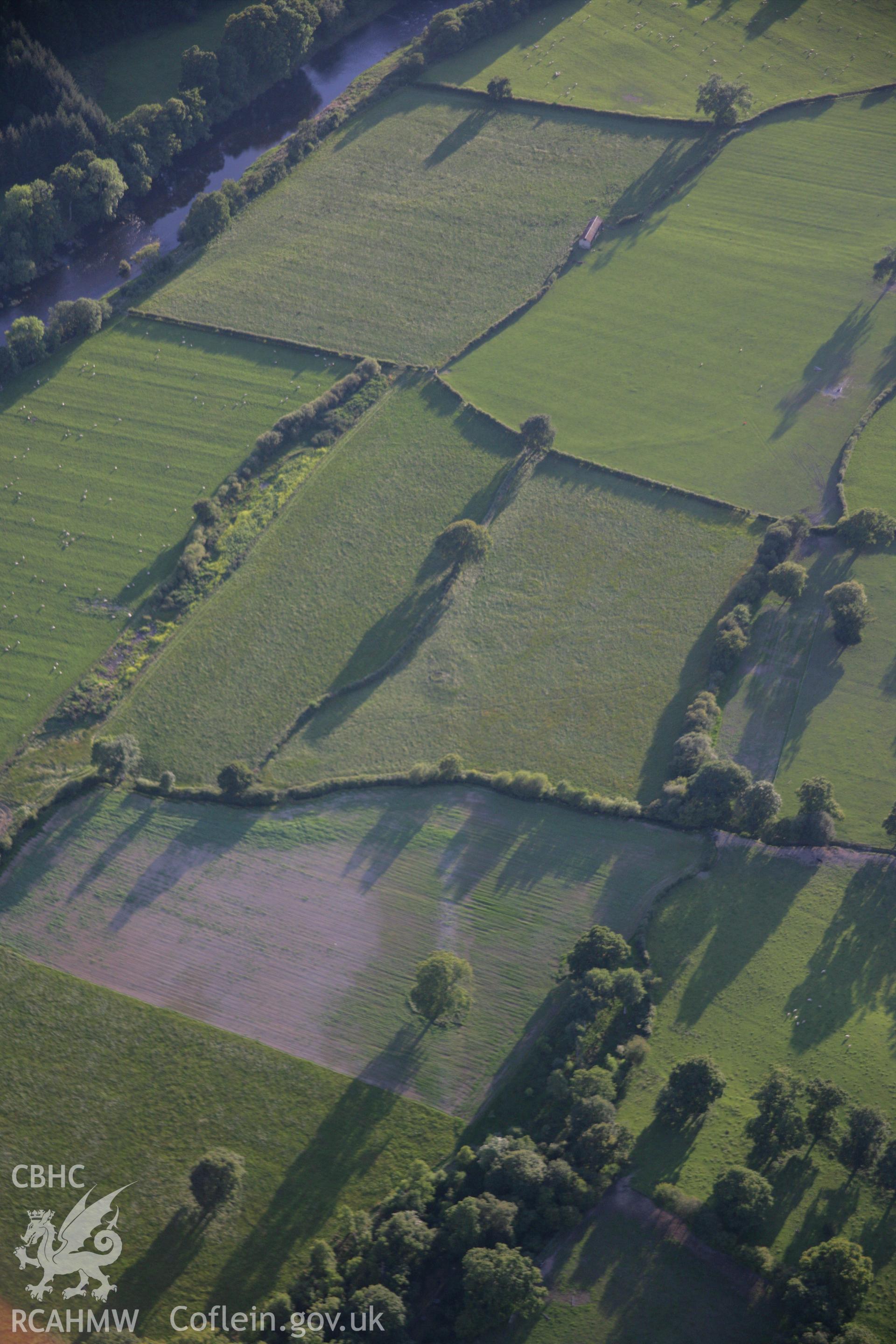 RCAHMW colour oblique aerial photograph showing road to the east of Penmincae Roman Fortlet, Disserth. Taken on 08 August 2007 by Toby Driver