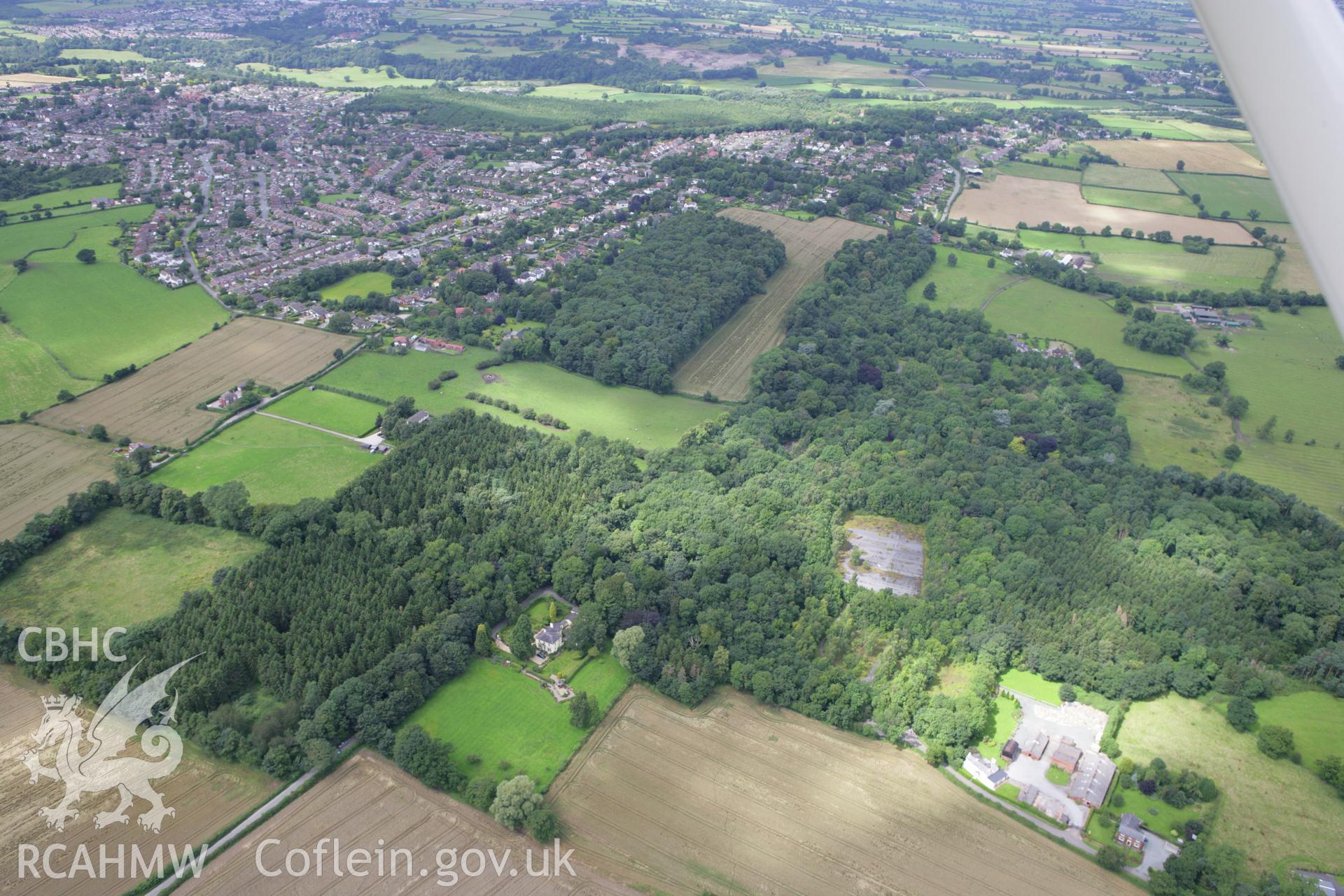 RCAHMW colour oblique aerial photograph showing suburban edge of Wrexham with Park Leigh Farm and Horsley Hall and Garden. Taken on 24 July 2007 by Toby Driver