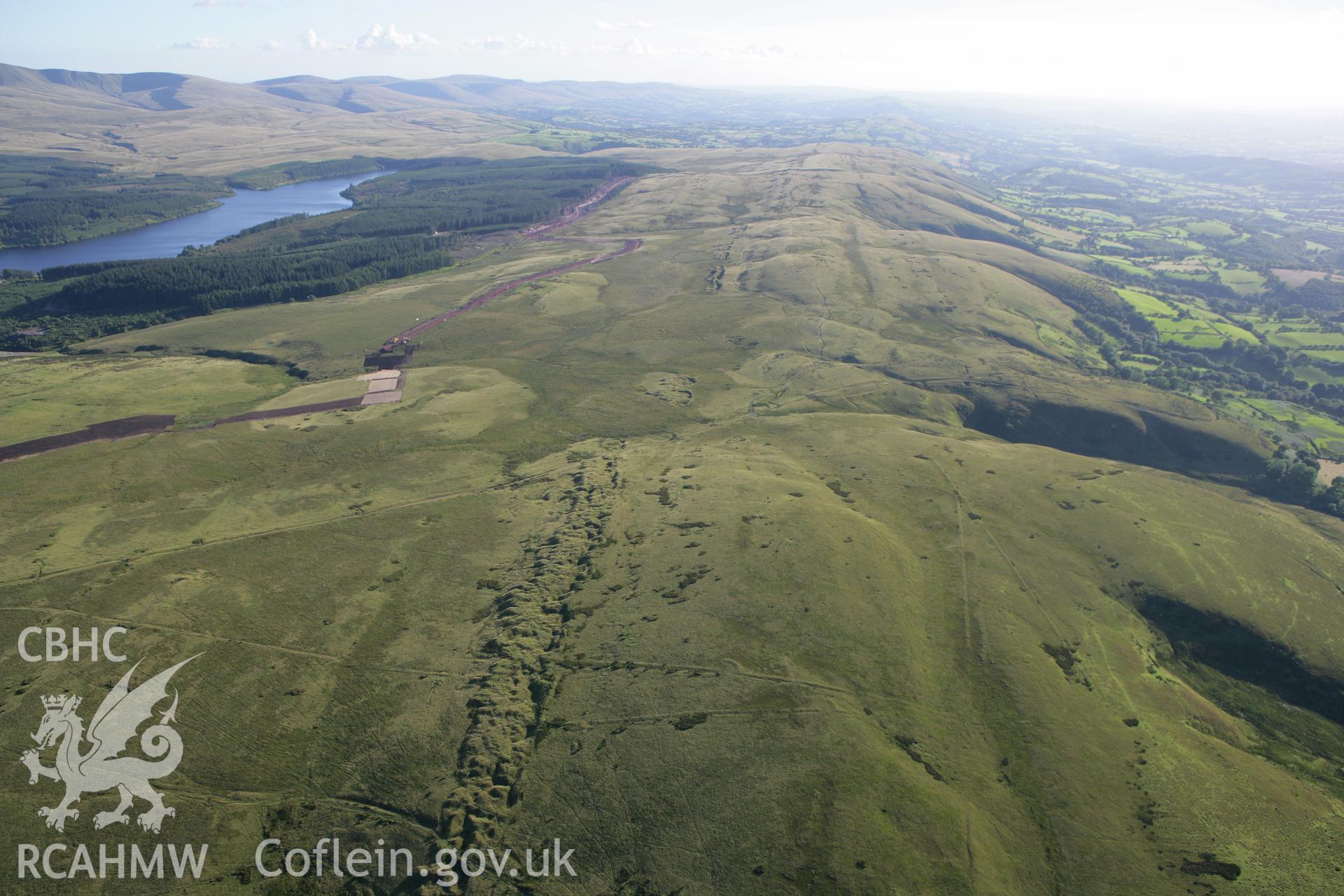 RCAHMW colour oblique aerial photograph of Y Pigwn Roman Camps, Mynydd Bach Trecastell. Taken on 08 August 2007 by Toby Driver