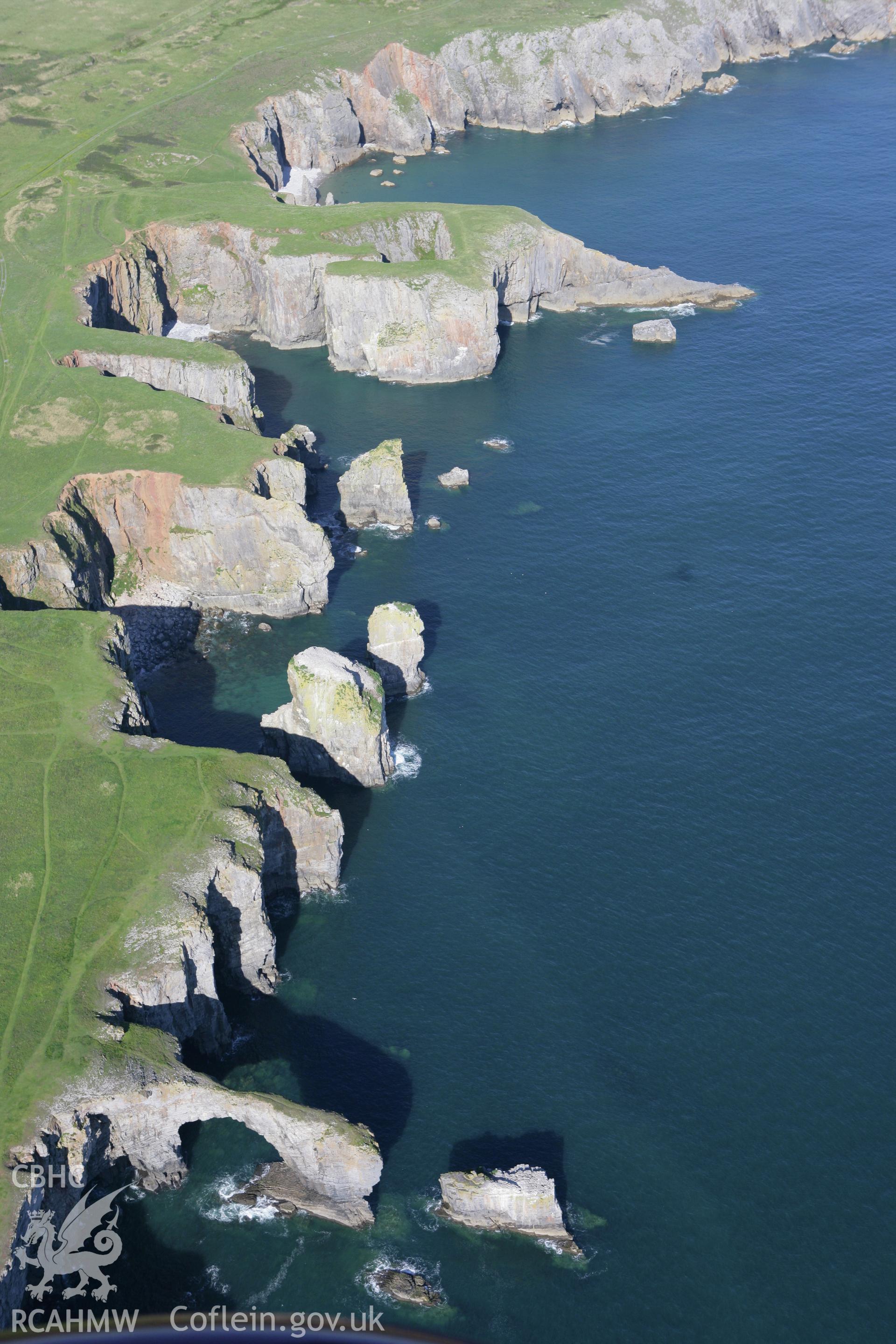 RCAHMW colour oblique aerial photograph of the Green Bridge (of Wales) and Elegug Stacks. Taken on 30 July 2007 by Toby Driver