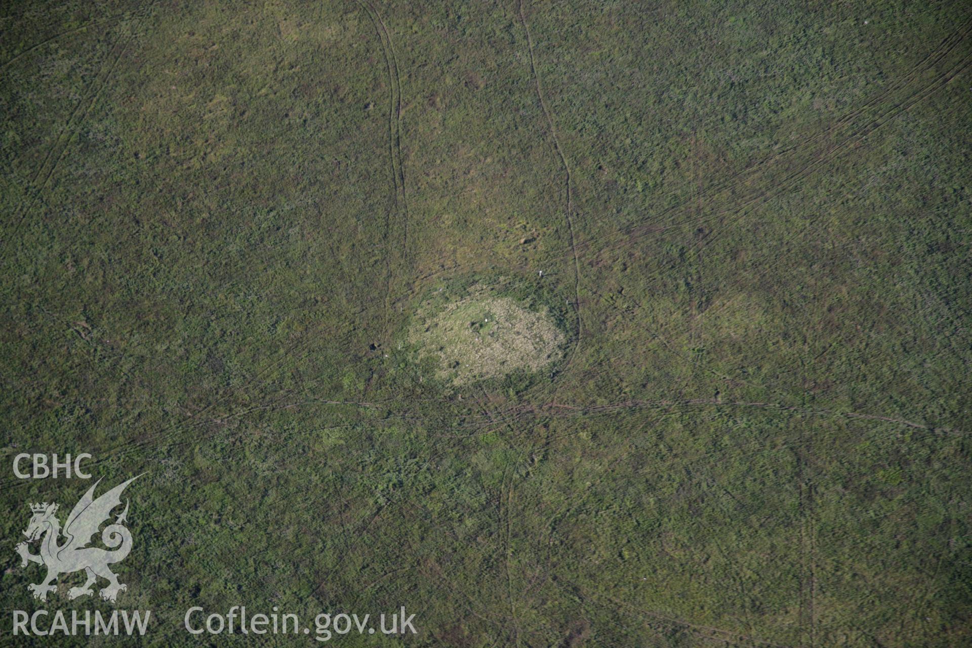 RCAHMW colour oblique aerial photograph of Bryn Melin Cairn, Llandeilor Fan. Taken on 08 August 2007 by Toby Driver