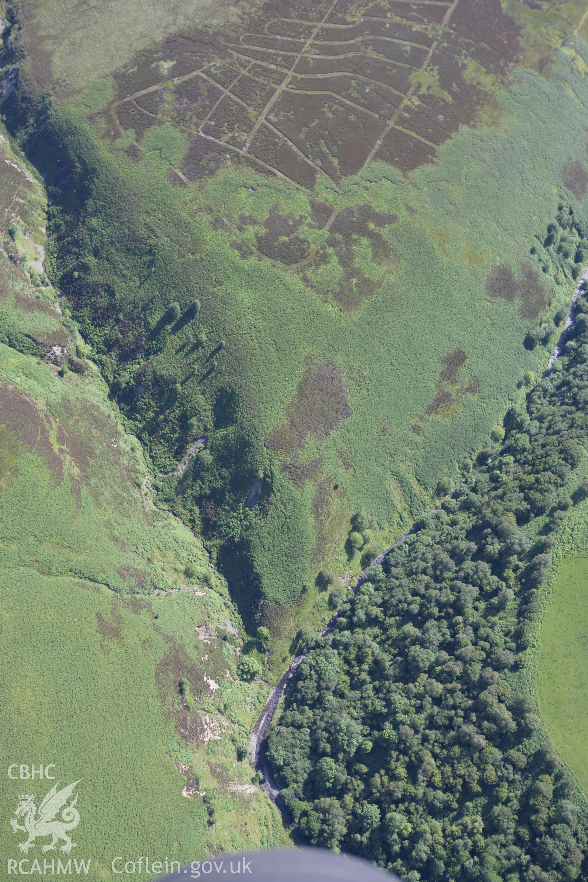 RCAHMW colour oblique aerial photograph showing landscape of Llyn Aled Isaf Mesolithic Occupation Site. Taken on 31 July 2007 by Toby Driver