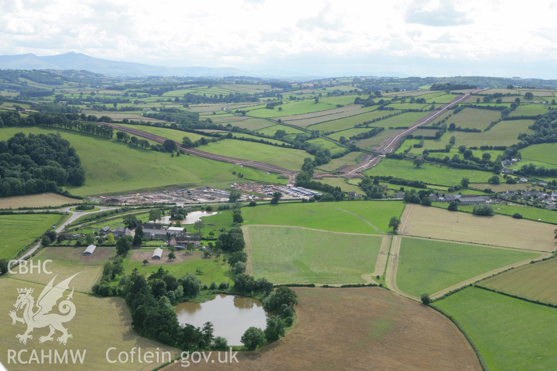 RCAHMW colour oblique aerial photograph of Llyswen Liquified Natural Gas (LNG) Pipeline Depot. Taken on 09 July 2007 by Toby Driver
