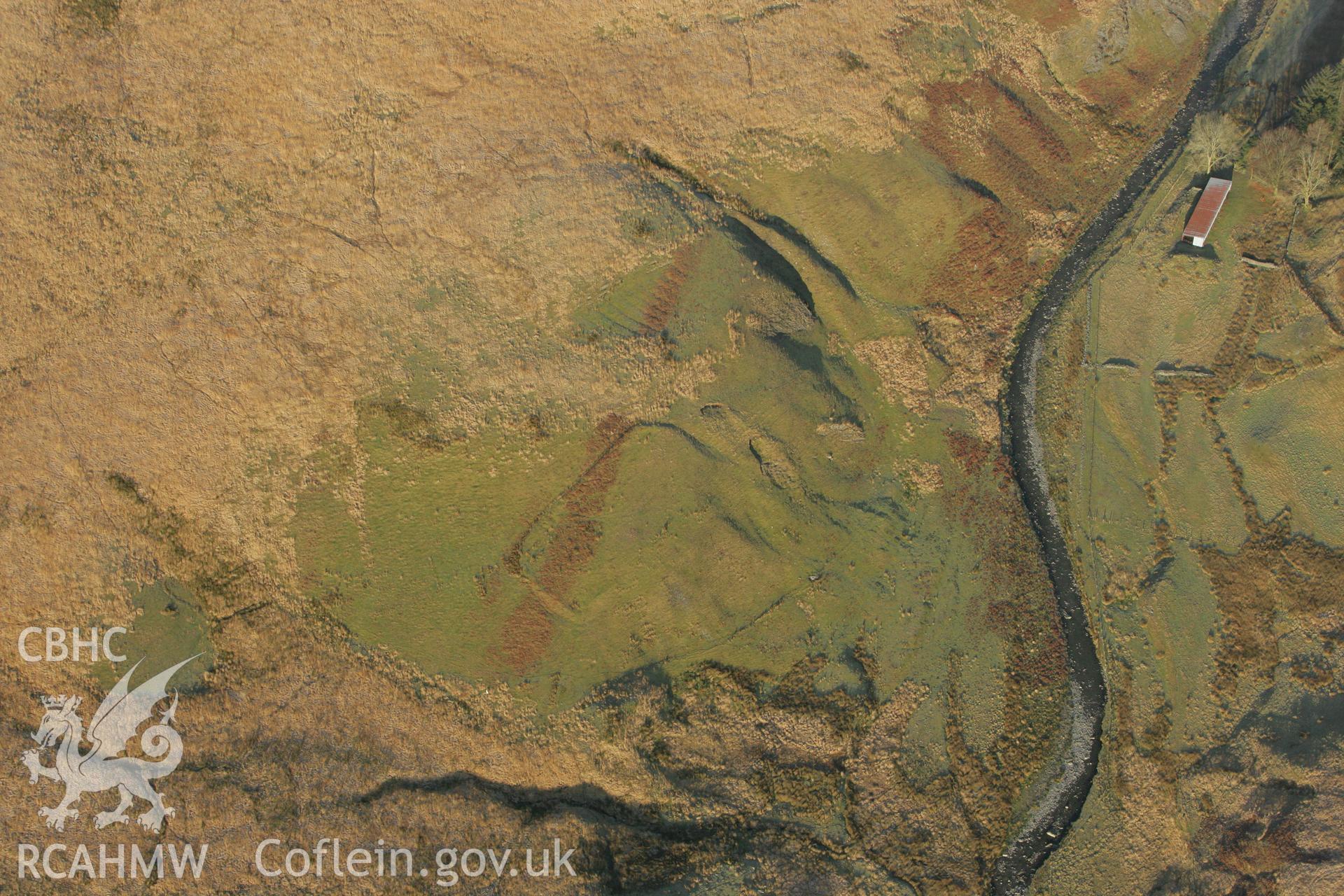 RCAHMW colour oblique photograph of Enclosures and cultivation features southwest of Lluest Dol-gwiail. Taken by Toby Driver on 20/12/2007.