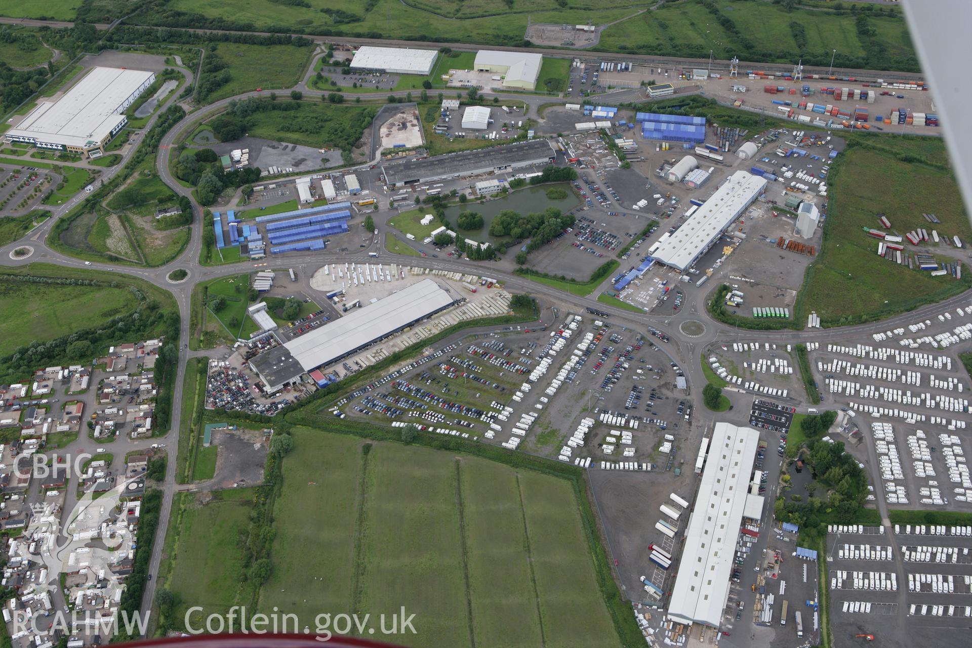 RCAHMW colour oblique aerial photograph of Wentlooge Industrial Park Dispersal Sheds. Taken on 30 July 2007 by Toby Driver