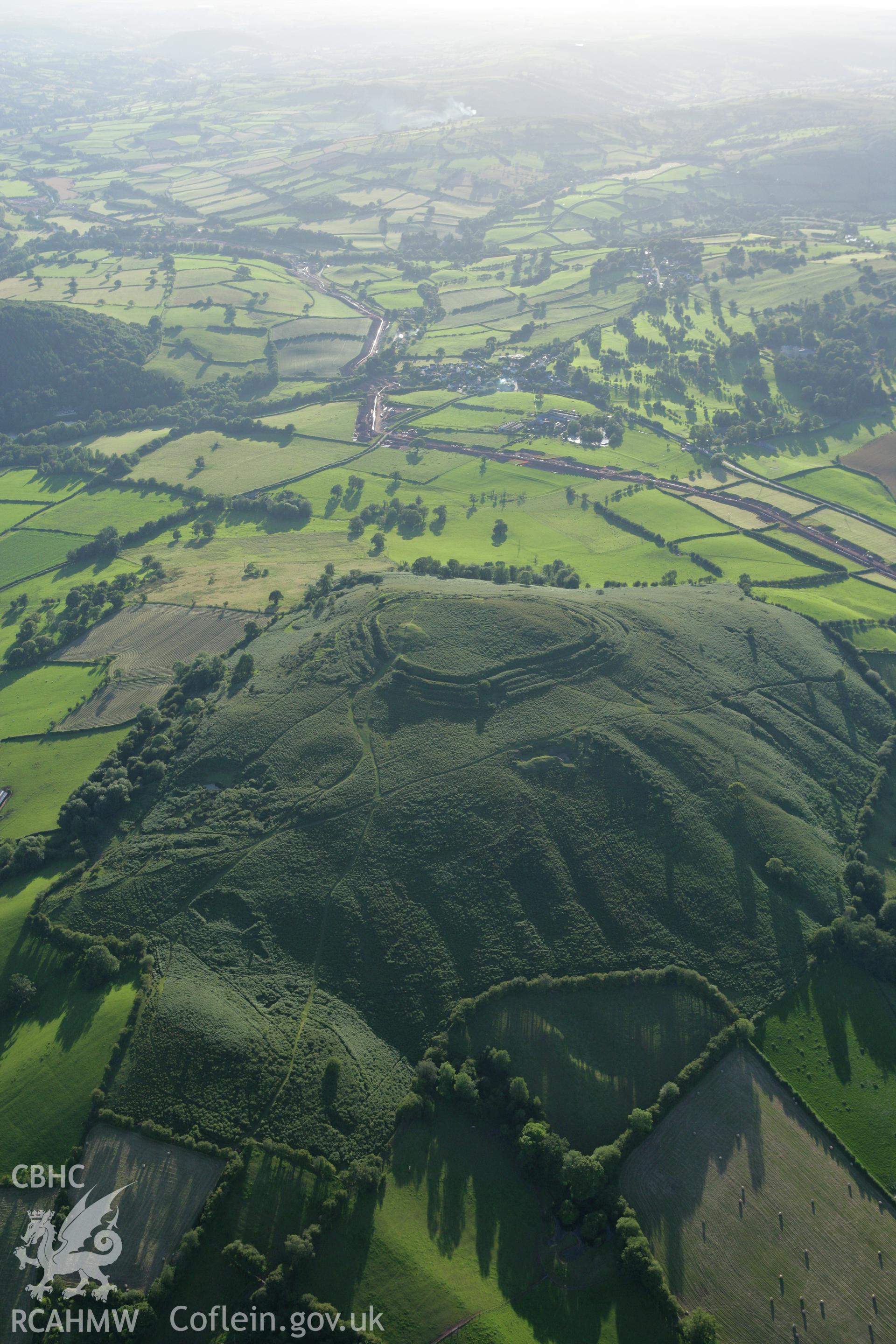 RCAHMW colour oblique aerial photograph of Pen-y-Crug Hillfort. Taken on 08 August 2007 by Toby Driver