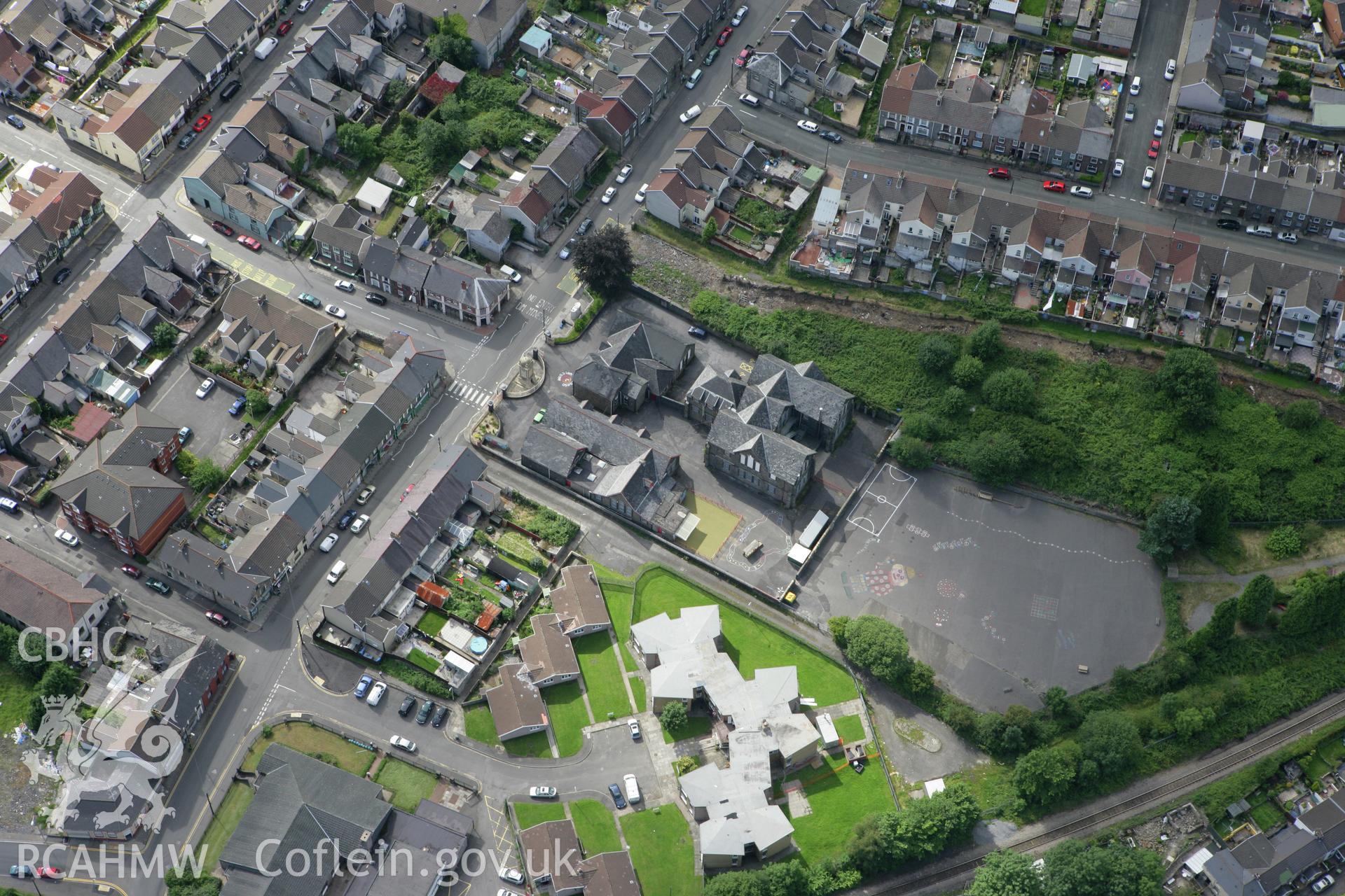 RCAHMW colour oblique aerial photograph of Abercynon War Memorial, the school and surounding houses. Taken on 30 July 2007 by Toby Driver