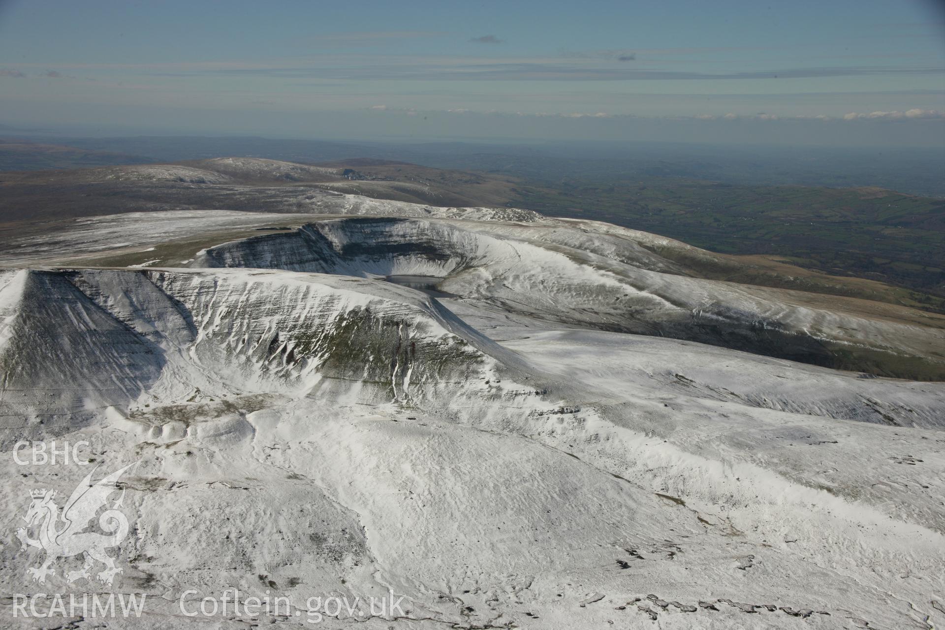 RCAHMW colour oblique aerial photograph of Fan Foel Round Barrow and Bannau Sir Gaer in winter landscape. Taken on 21 March 2007 by Toby Driver