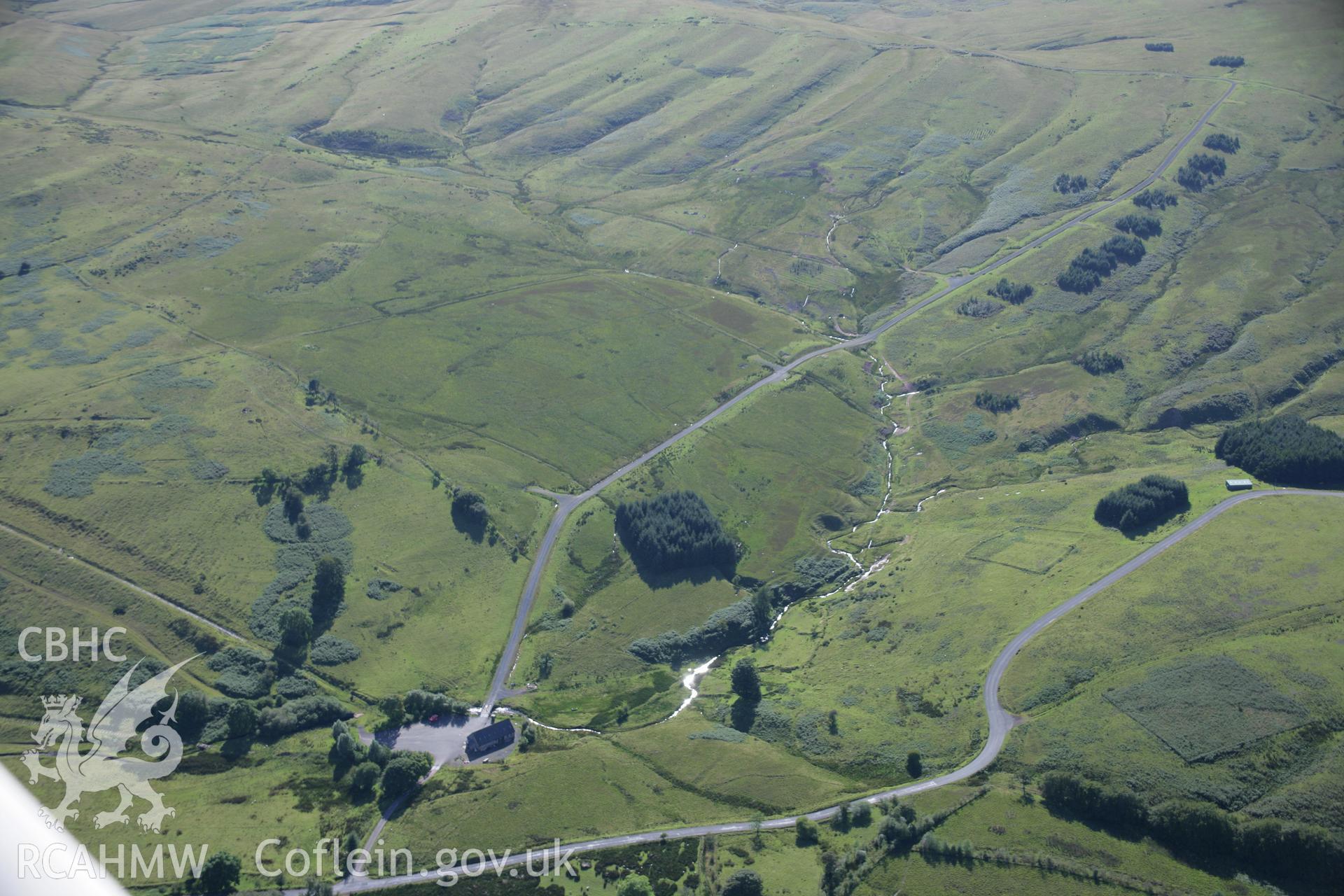 RCAHMW colour oblique aerial photograph of Disgwylfa Farmstead with redundant track targets. Taken on 08 August 2007 by Toby Driver