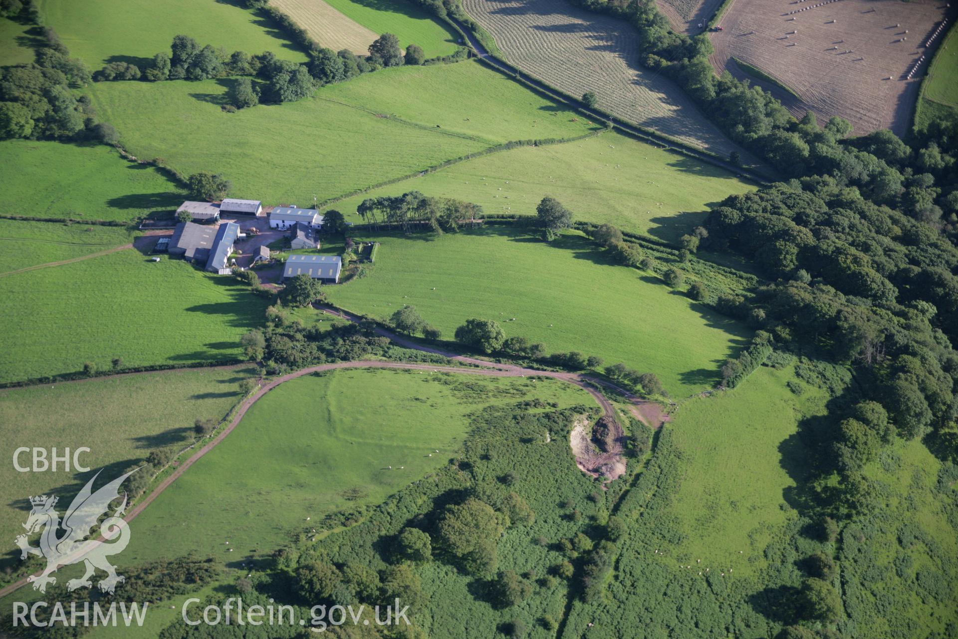 RCAHMW colour oblique aerial photograph of earthwork enclosure near Alltycerrig. Taken on 08 August 2007 by Toby Driver