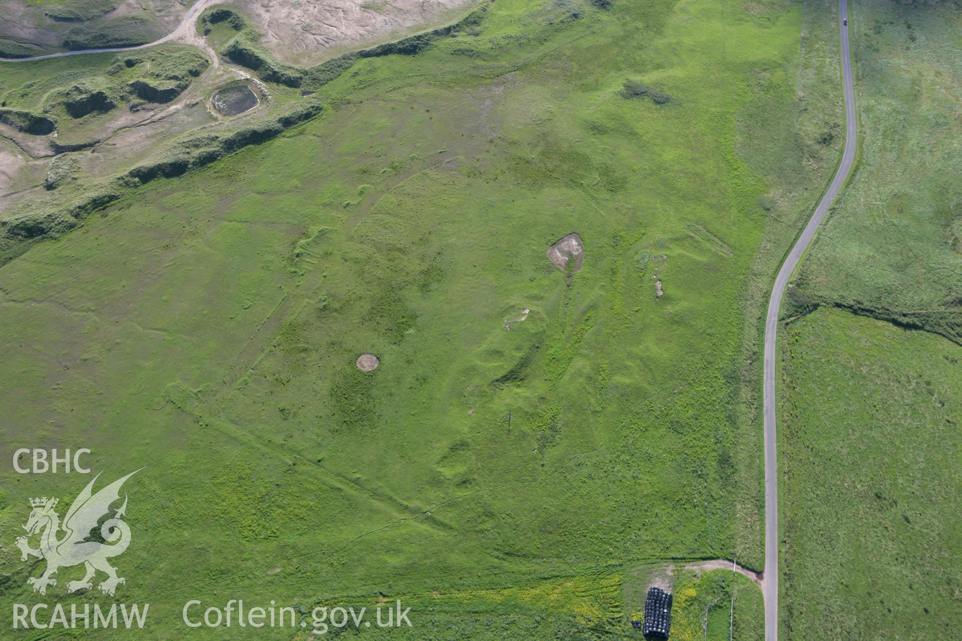 RCAHMW colour oblique photograph of Brownslade burrows, earthworks. Taken by Toby Driver on 30/07/2007.