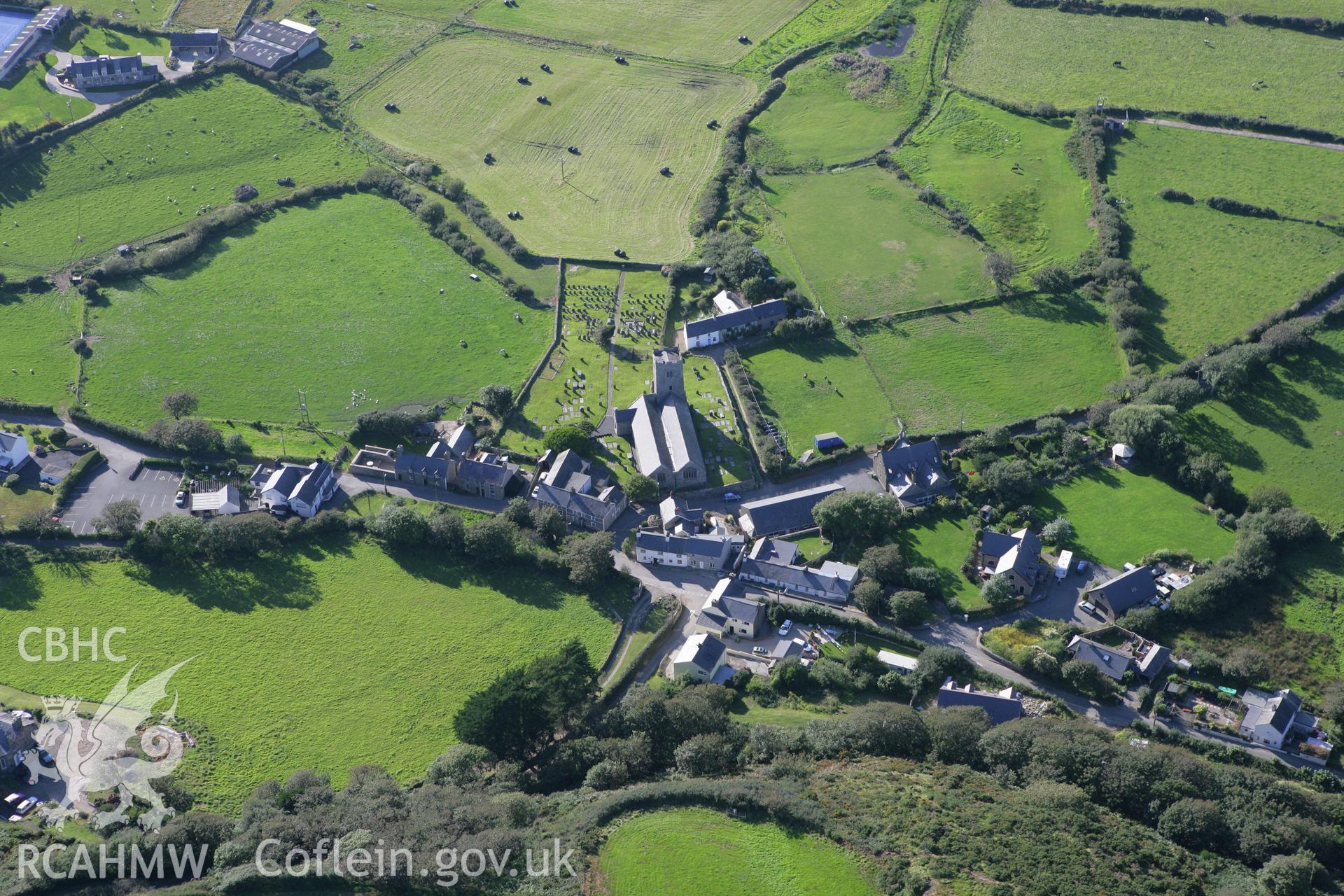 RCAHMW colour oblique aerial photograph of Llanengan Parish Church and village. Taken on 06 September 2007 by Toby Driver