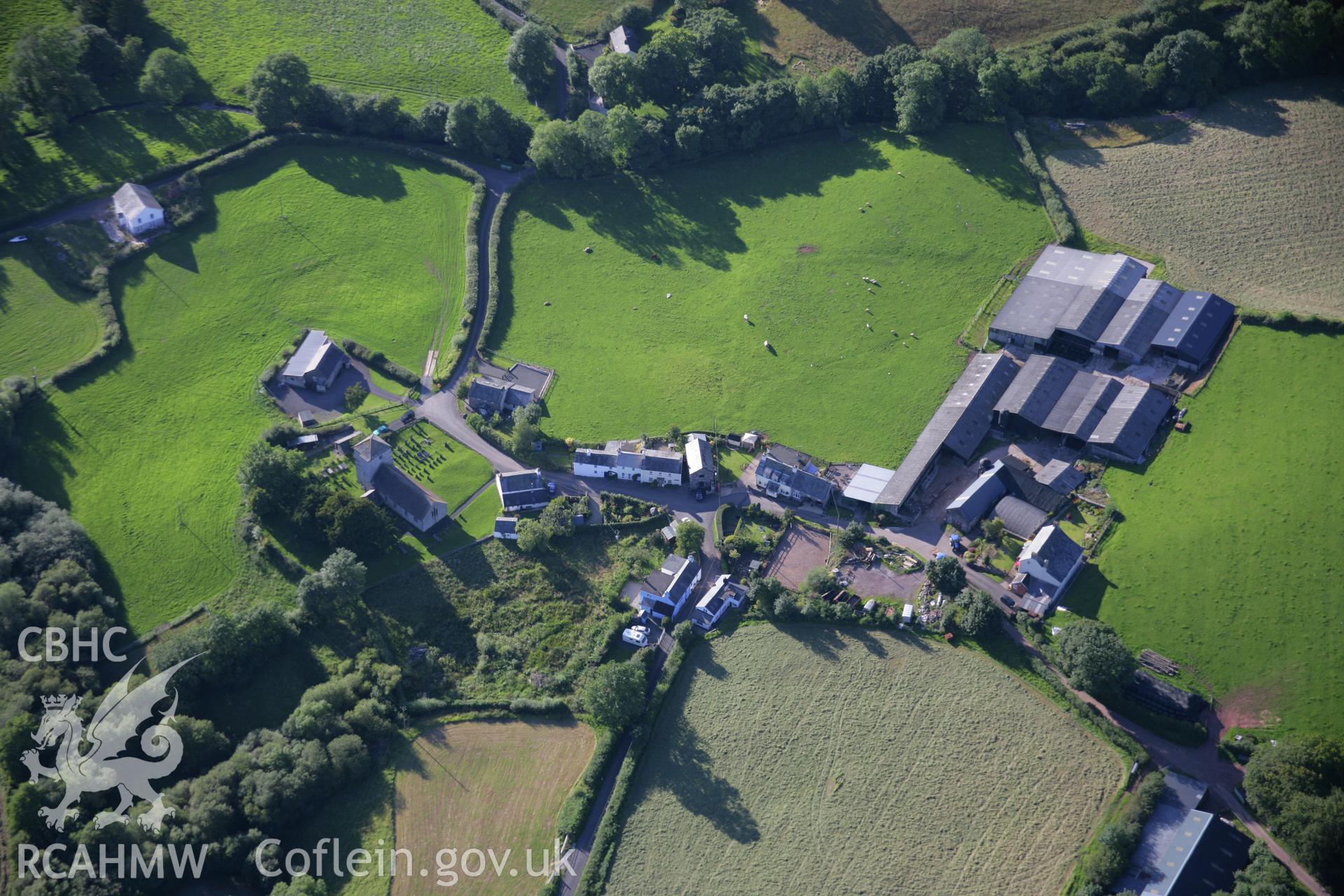 RCAHMW colour oblique aerial photograph of Llanfihangel Nant Bran village. Taken on 08 August 2007 by Toby Driver