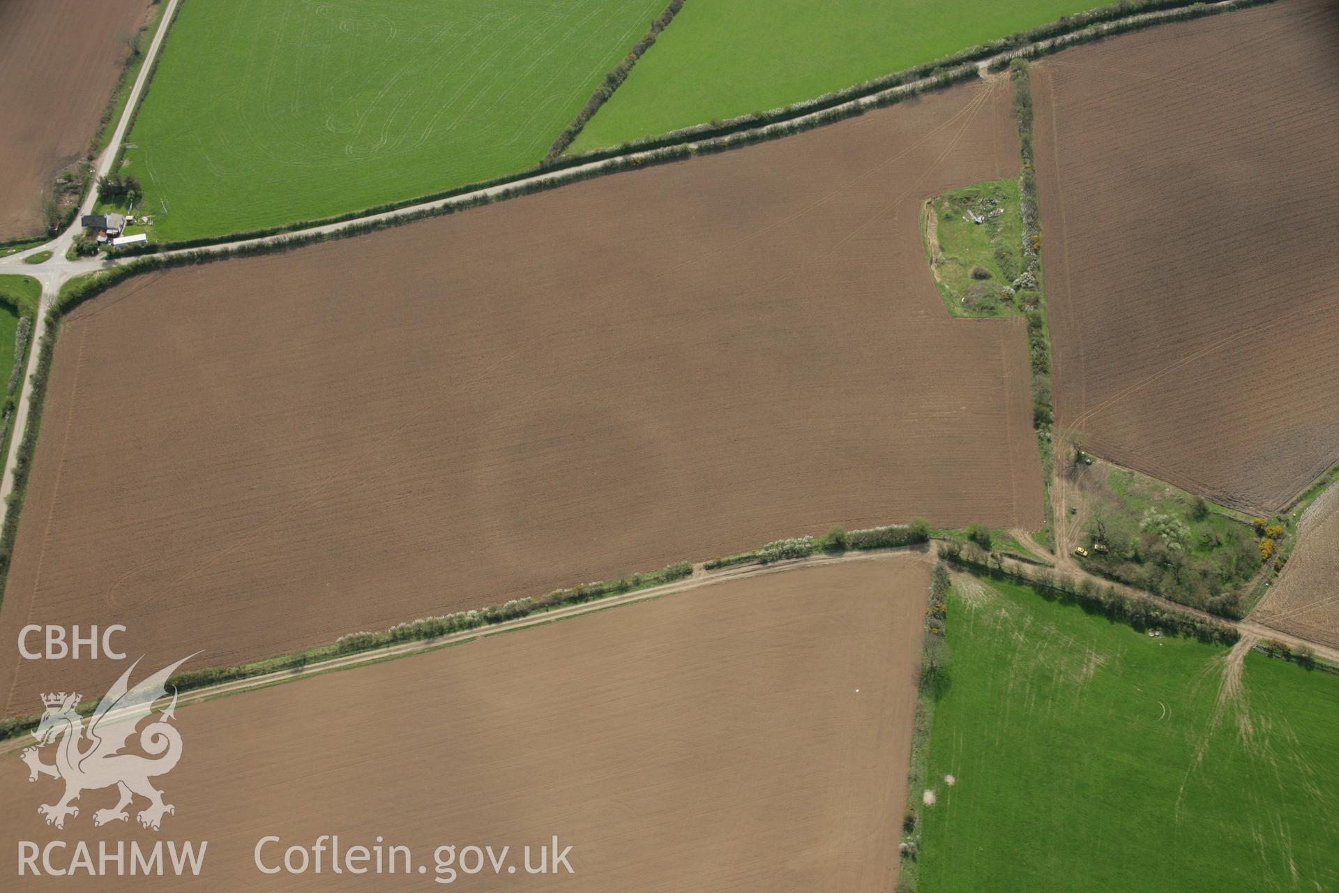 RCAHMW colour oblique aerial photograph of the Post-Coch cropmark enclosure northeast  of Nevern. Taken on 17 April 2007 by Toby Driver