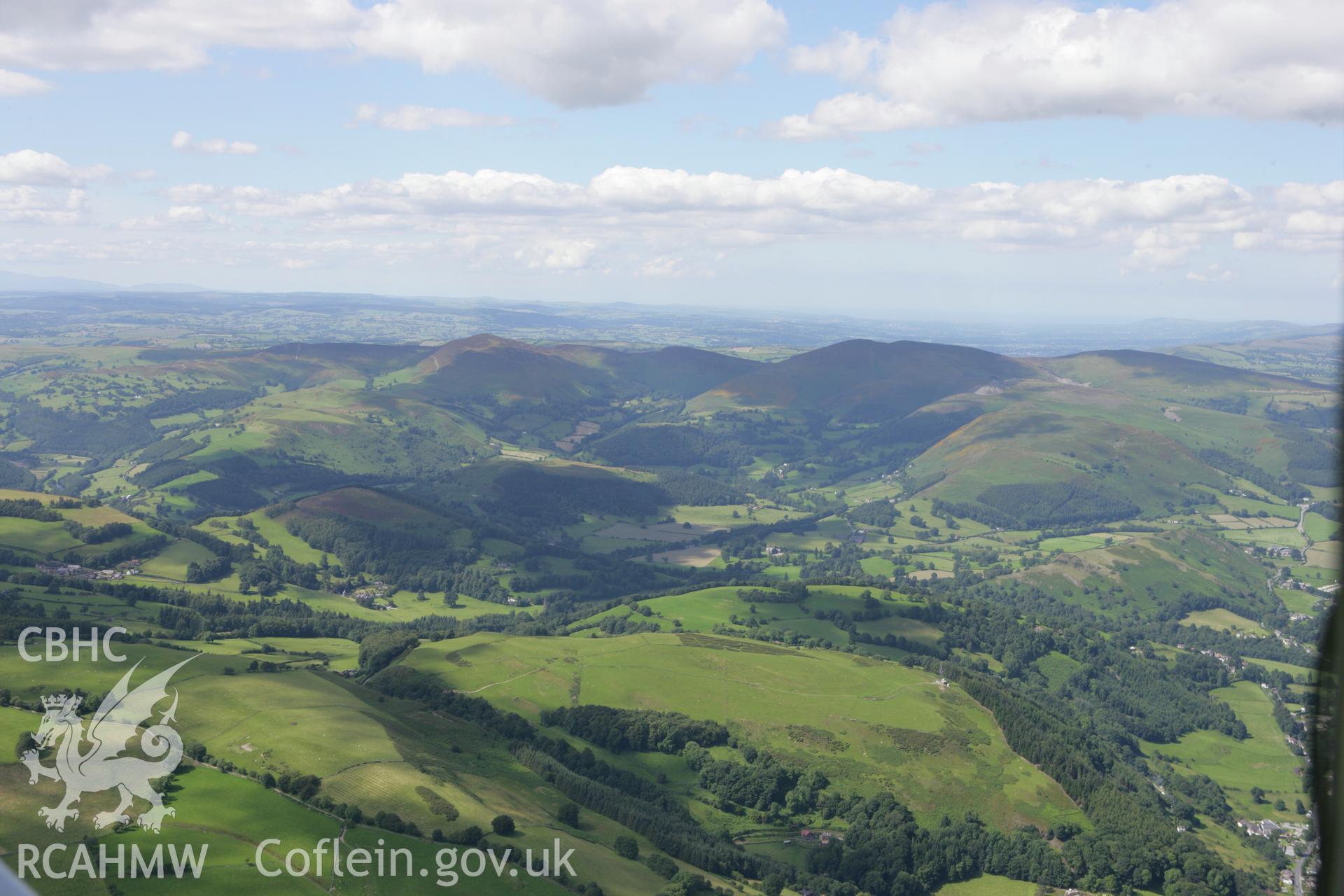 RCAHMW colour oblique aerial photograph of Moel-y-Gaer Hillfort and distant landscape towards Llantysilio Mountain. Taken on 31 July 2007 by Toby Driver
