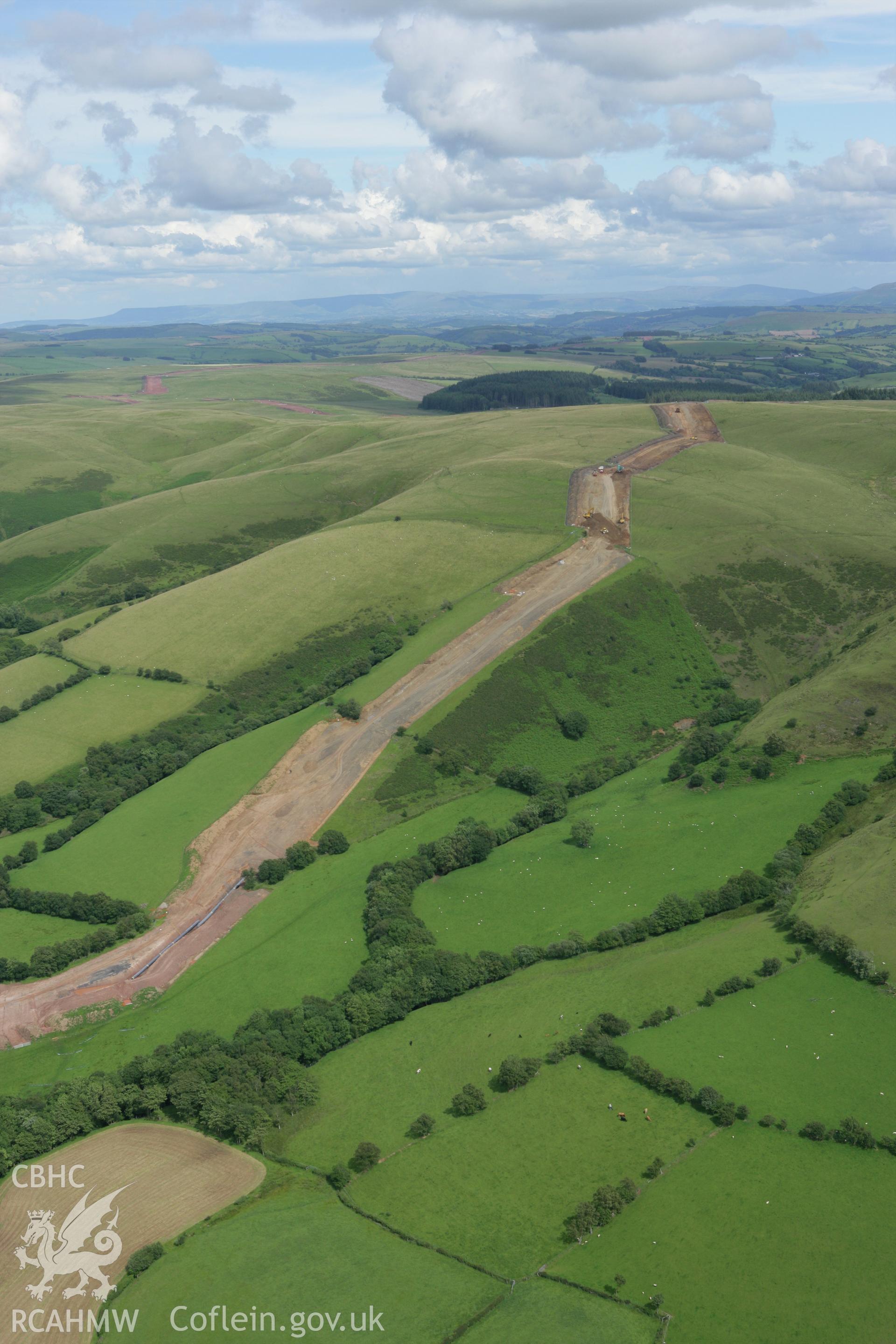 RCAHMW colour oblique aerial photograph of Mynydd Myddfai Bank with LNG pipeline climbing Craig Cwm-Clyd. Taken on 09 July 2007 by Toby Driver