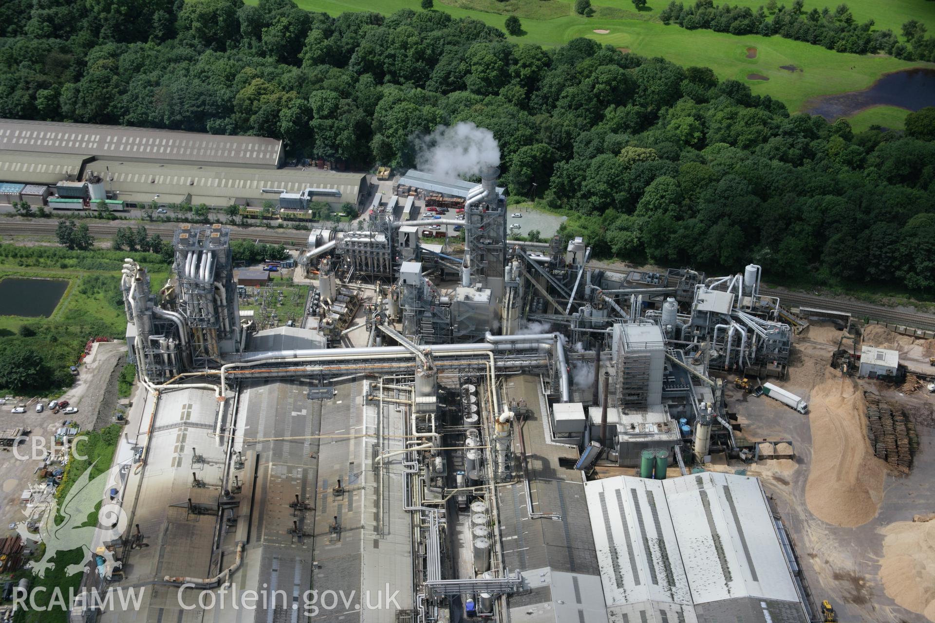 RCAHMW colour oblique aerial photograph of Woodchip factory, Chirk. Taken on 24 July 2007 by Toby Driver