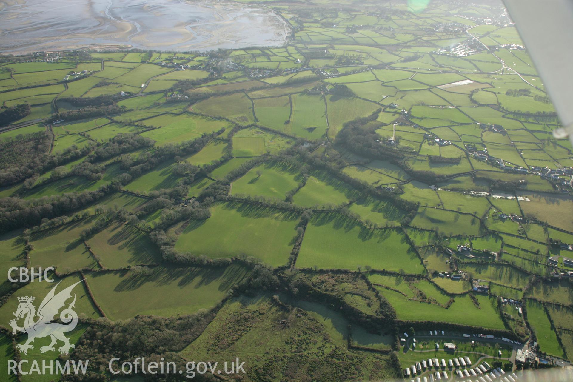 RCAHMW colour oblique aerial photograph of the Viking settlement at Glyn, Llanbedrgoch. Taken on 25 January 2007 by Toby Driver
