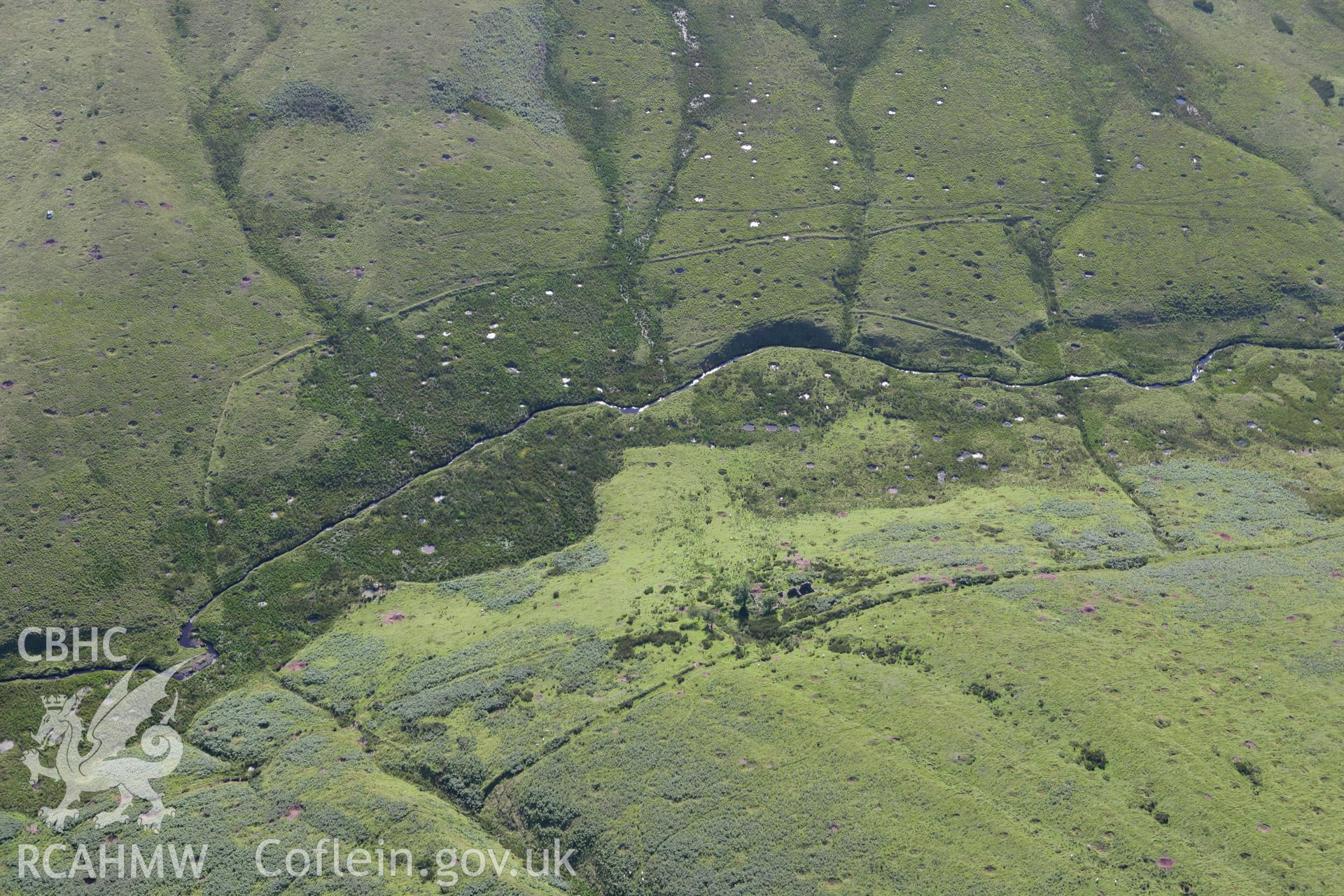 RCAHMW colour oblique aerial photograph of Cwm-car Deserted Farmstead. Taken on 08 August 2007 by Toby Driver