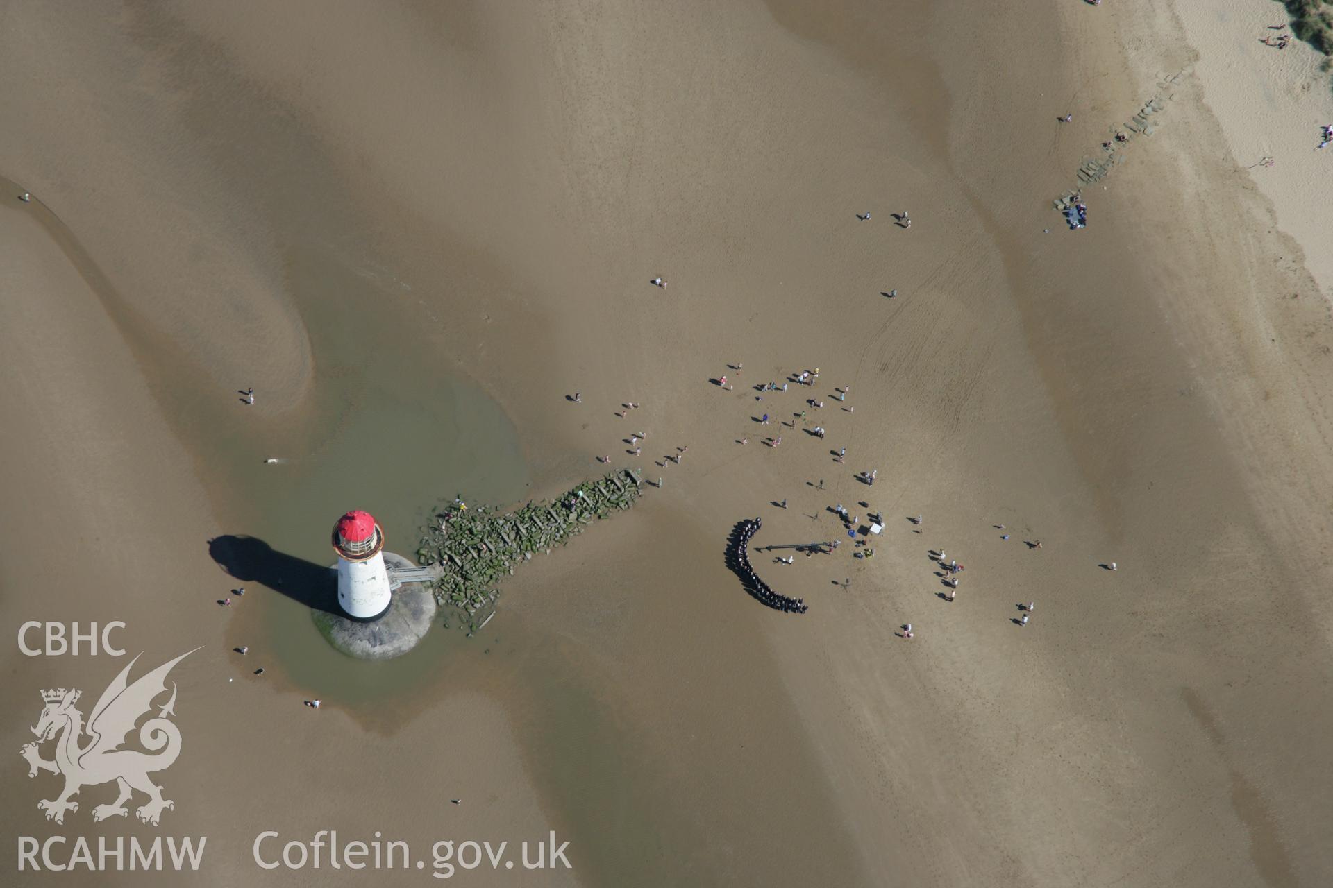 RCAHMW colour oblique aerial photograph of Point of Ayr Lighthouse with a male voice choir assembled. Taken on 31 July 2007 by Toby Driver