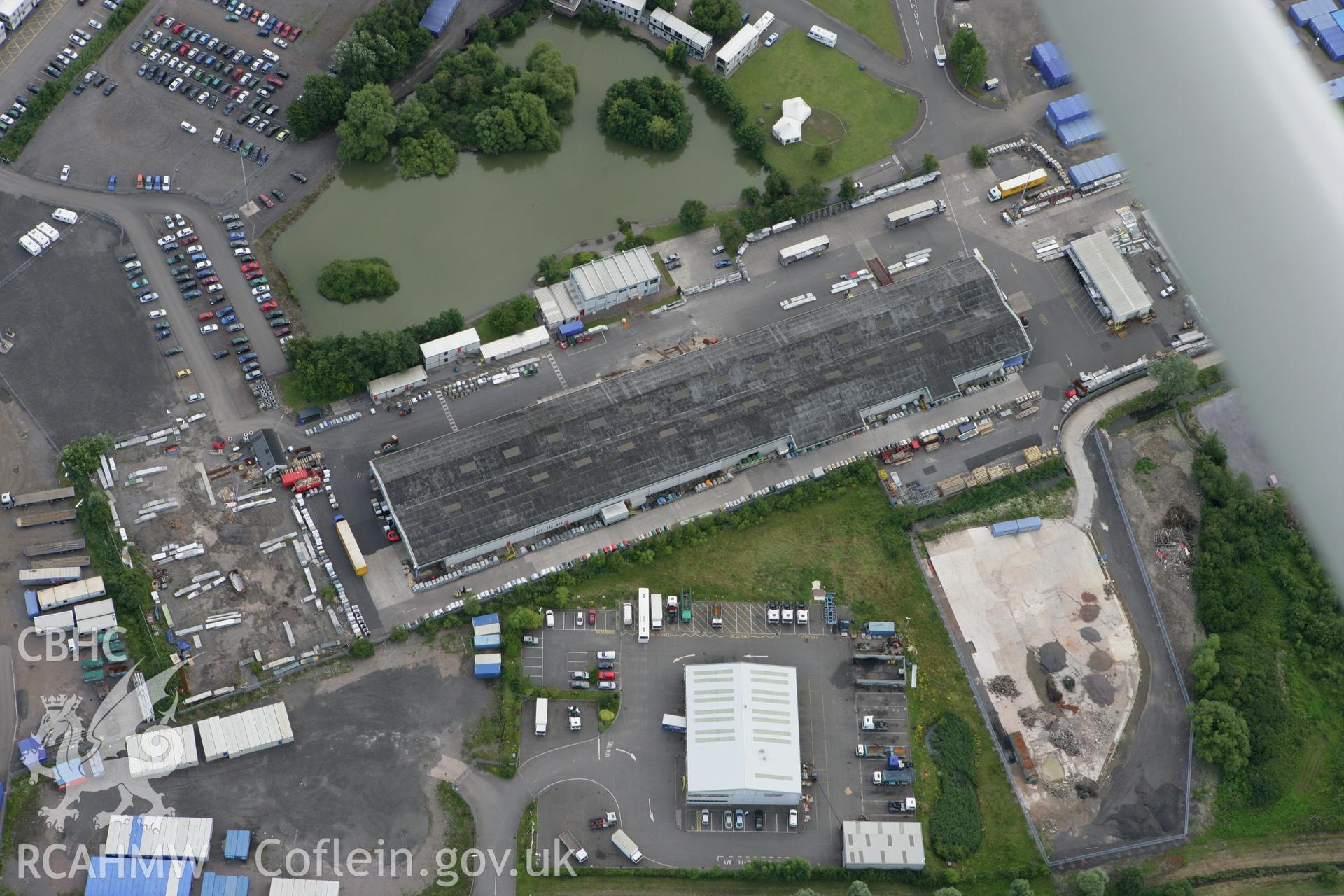 RCAHMW colour oblique aerial photograph of Wentlooge Industrial Park Dispersal Sheds. Taken on 30 July 2007 by Toby Driver