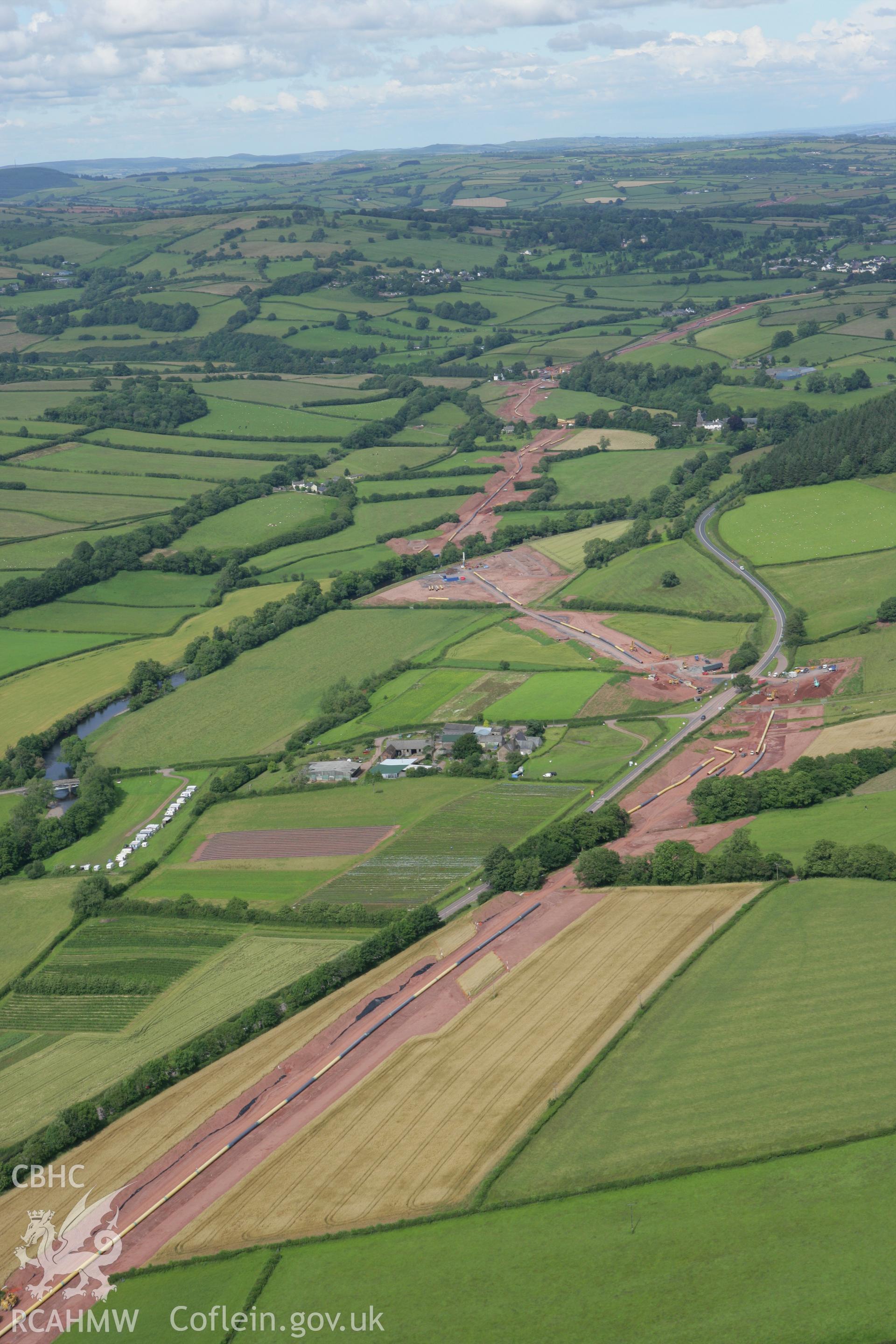 RCAHMW colour oblique aerial photograph of Aberbran-Fawr House and LNG pipleline viewed from the north-west. Taken on 09 July 2007 by Toby Driver