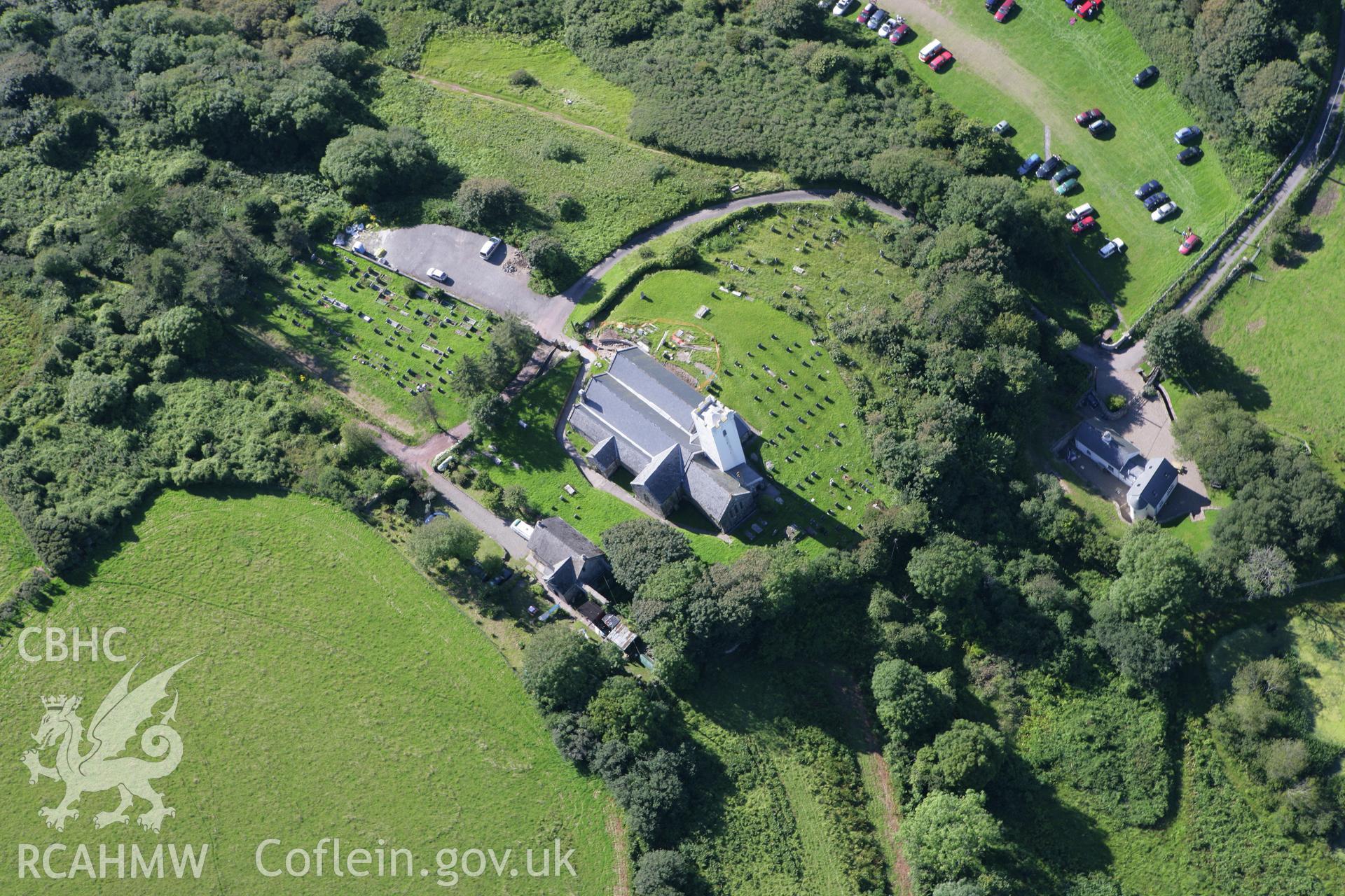 RCAHMW colour oblique aerial photograph of St James' Church, Manorbier. Taken on 30 July 2007 by Toby Driver