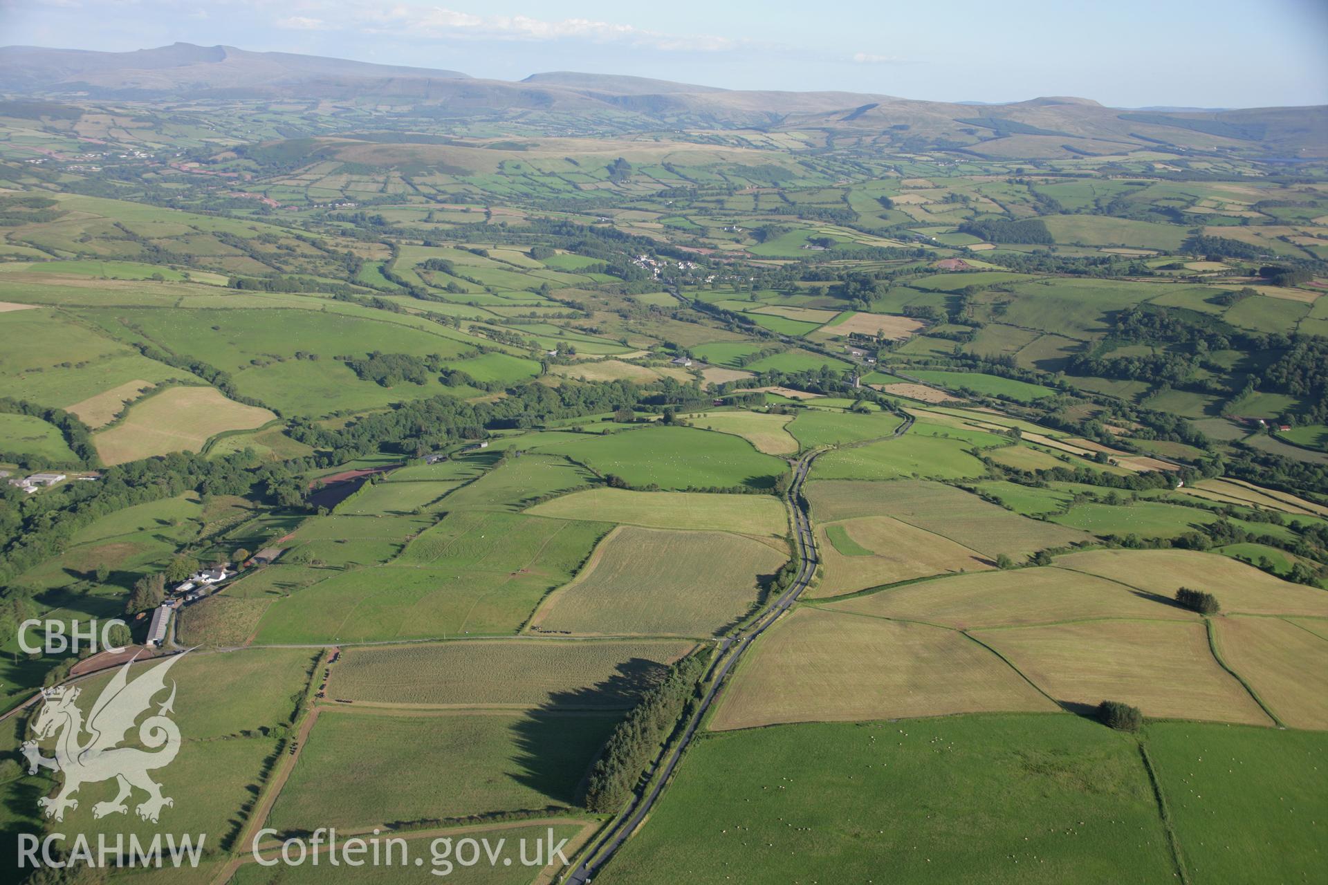 RCAHMW colour oblique aerial photograph of landscape to the north of Llwyel village. Taken on 08 August 2007 by Toby Driver