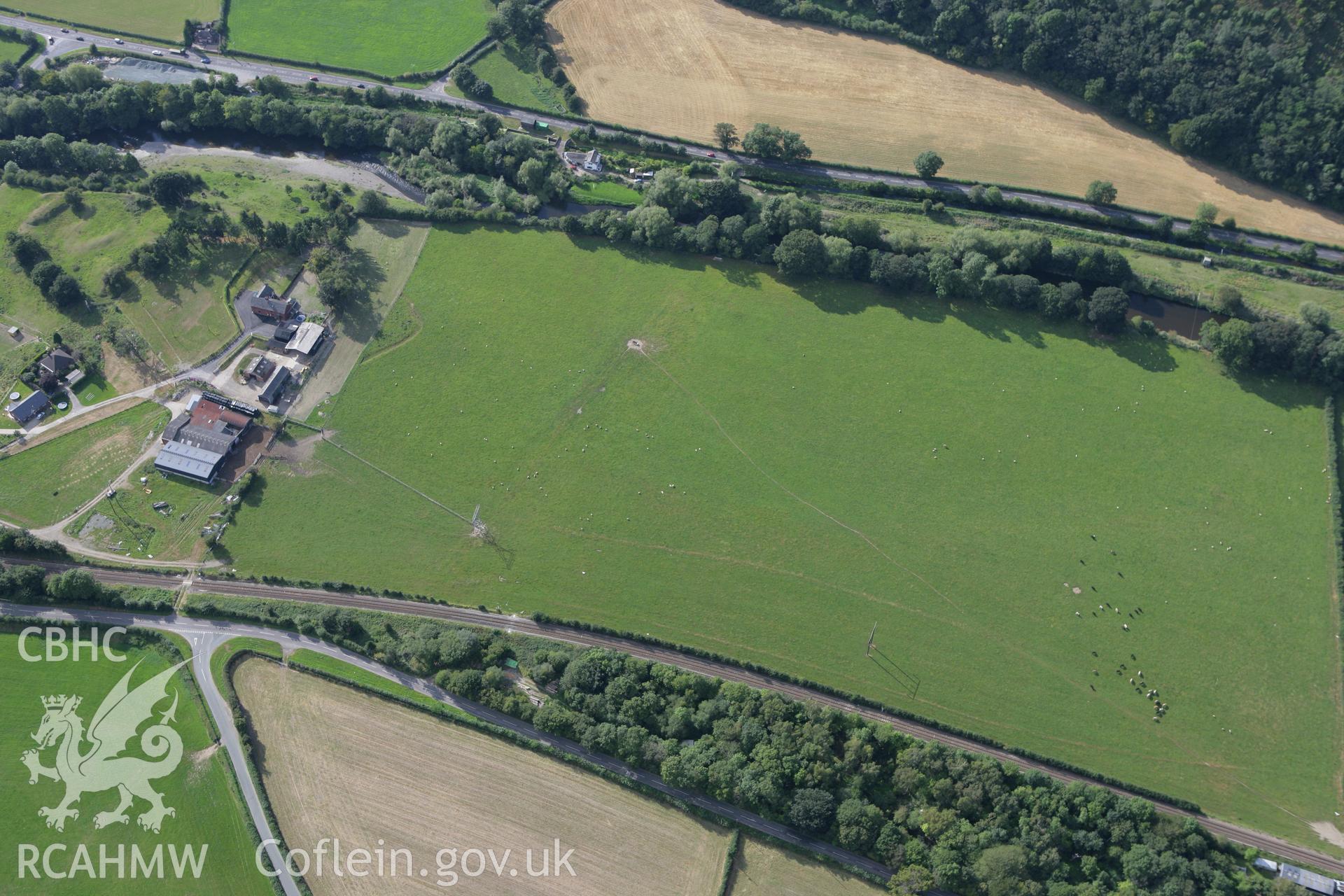 RCAHMW colour oblique aerial photograph of Bryn Derwen Castle and a field to the north. Taken on 06 September 2007 by Toby Driver