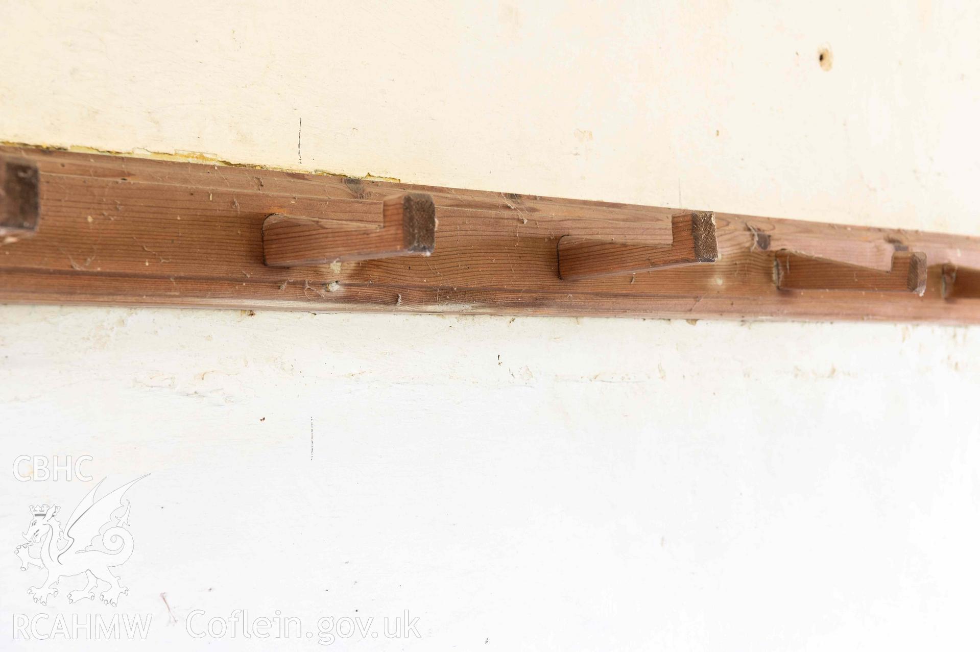 Capel Newydd - Detailed view of coathangers along the rear wall, taken from North-East