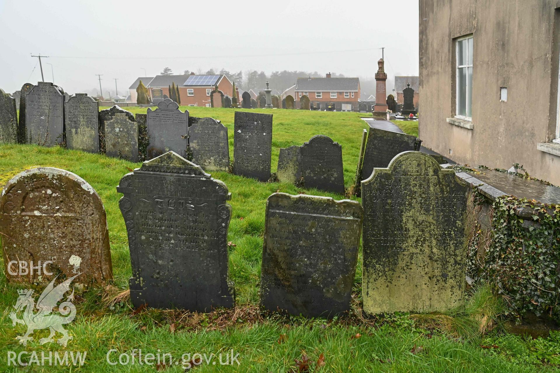 Bethlehem Welsh Independent Chapel - View of a row of gravestones by the chapel, taken from East