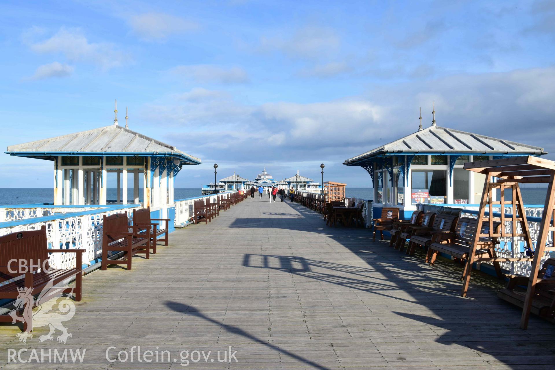 Llandudno Pier: view north-east along length of pier boardwalk, with central pair of kiosks