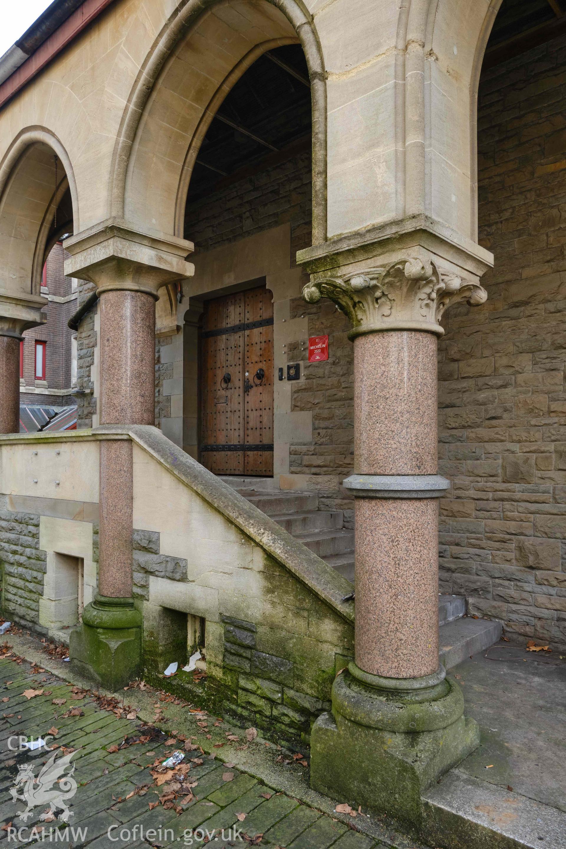 detail of porch showing arch with foliage capital, looking SE