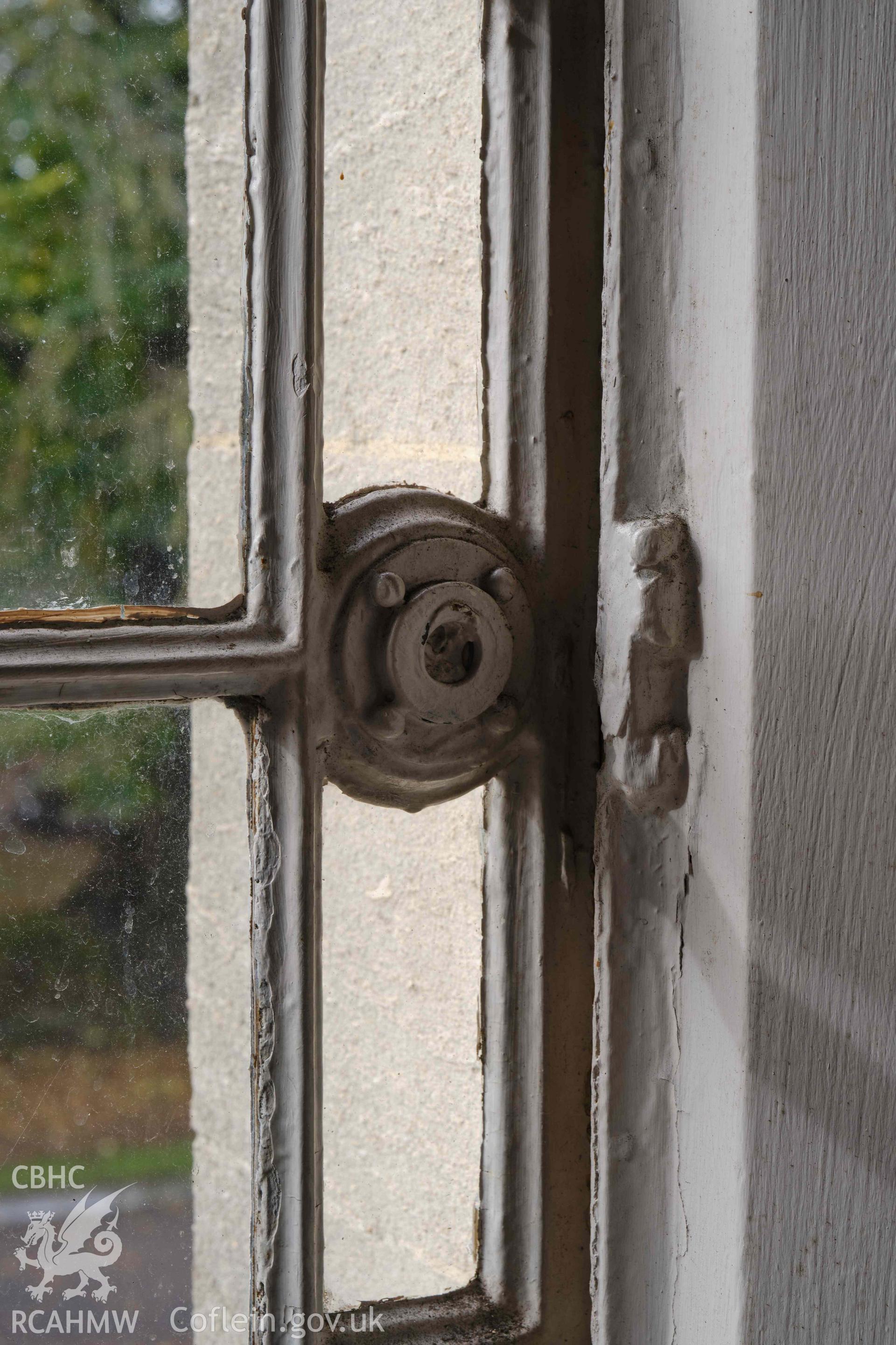 room 1.2, casement detail (missing handle) in W window, looking NW