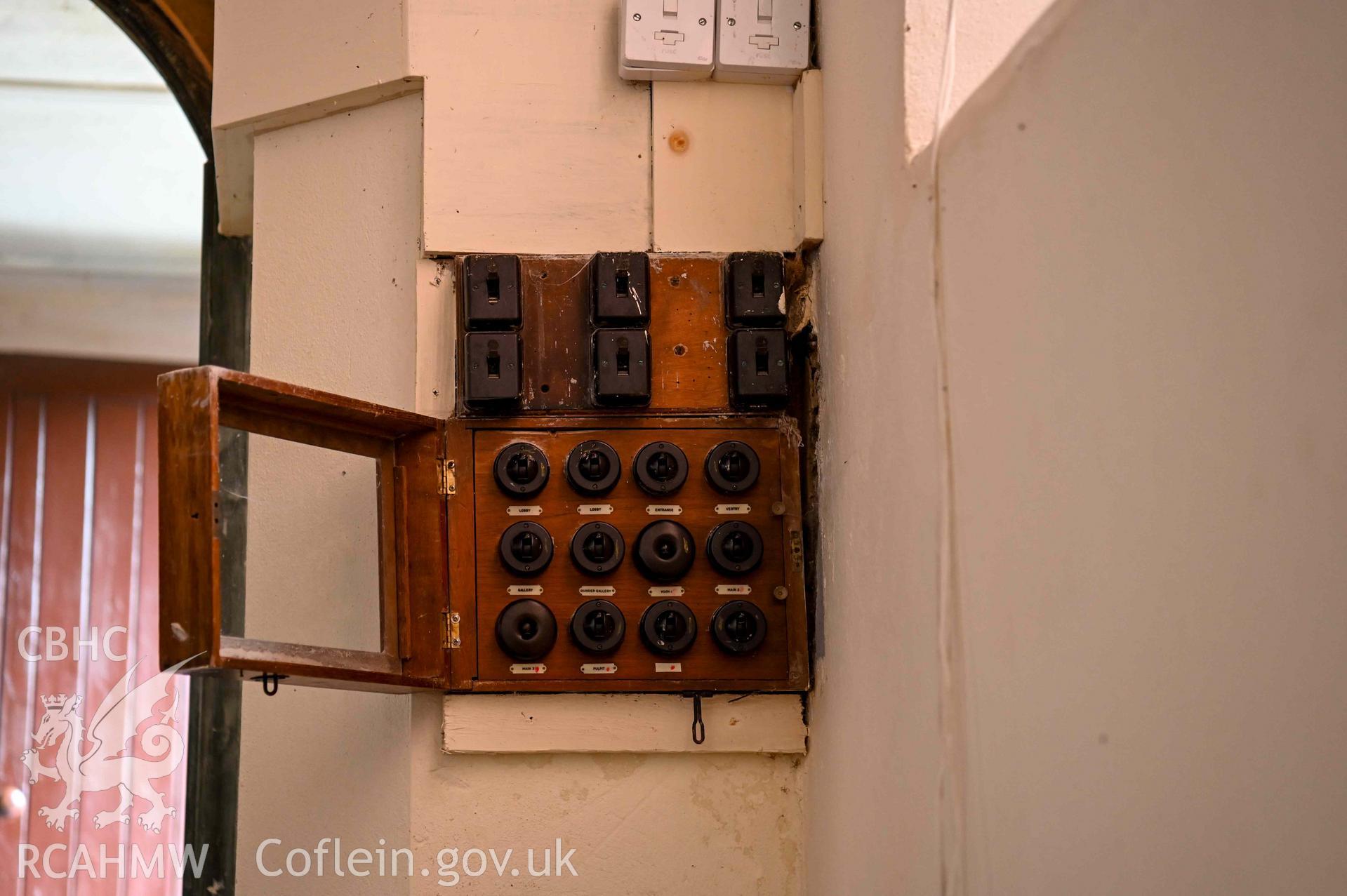 Tre-Wen Welsh Independent Chapel - Interior: Chapel, view of the light-switch switchboard by the entrance to the chapel, taken from West